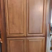 Wooden cabinet with four doors in a room.