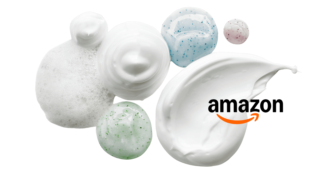 Various dollops and bubbles of creamy lotion or moisturizer with the Amazon logo on a black background.
