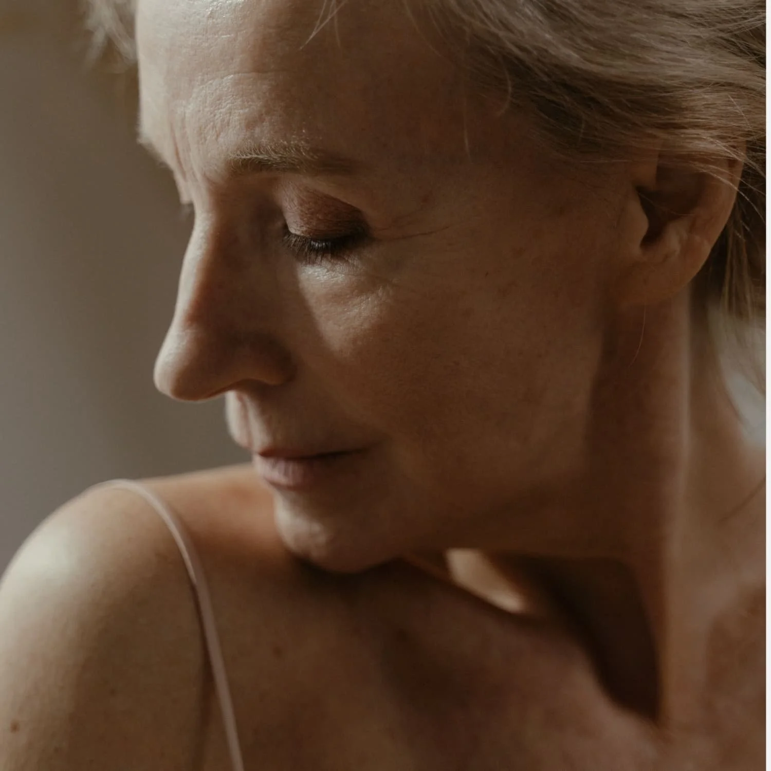 Close-up of a woman with her eyes closed, showing her face in peaceful contemplation.