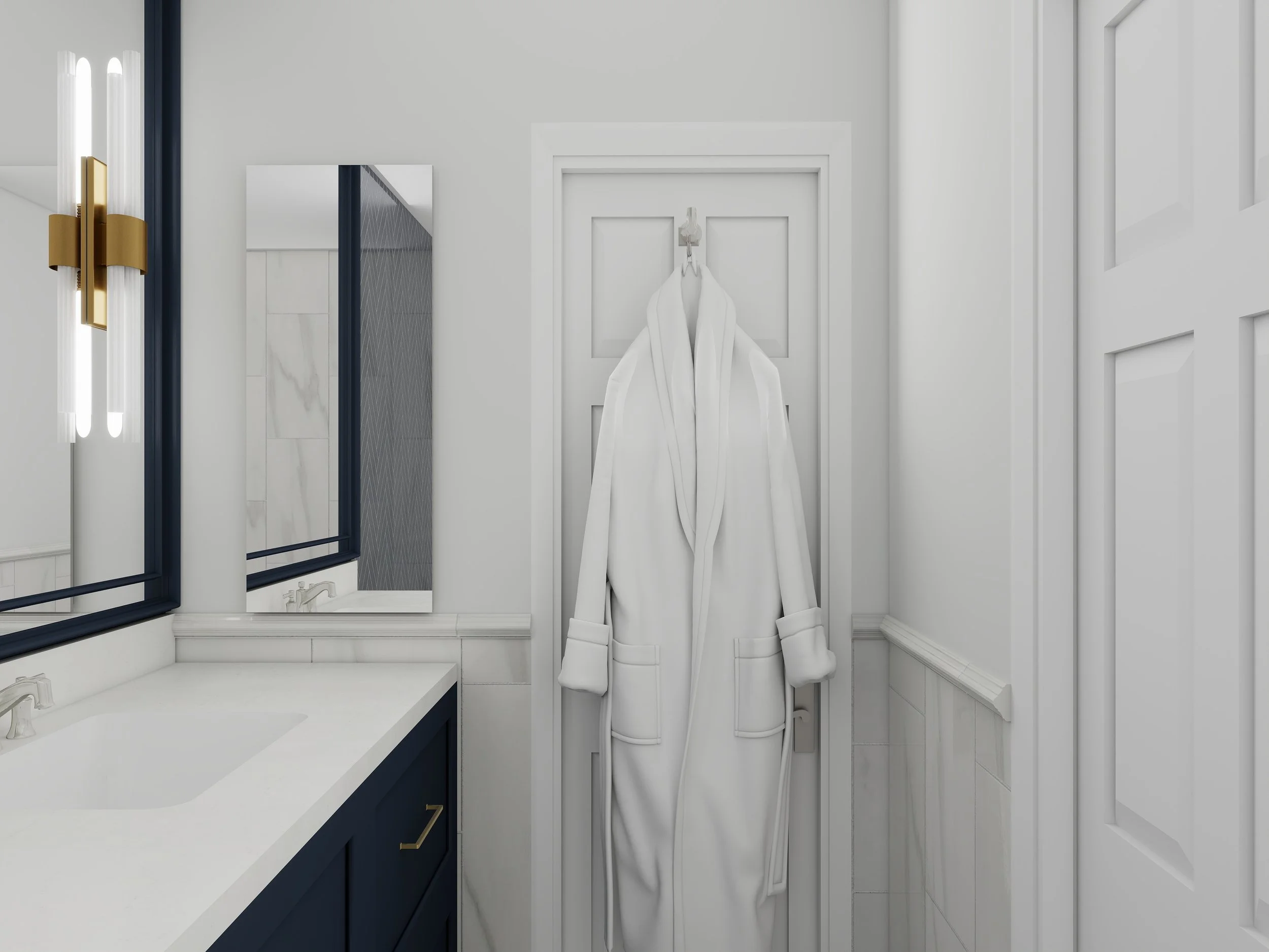 Modern bathroom with white walls, a white countertop with a double sink, a tall mirror, a stylish gold and white wall sconce, a navy blue vanity with gold handles, and a white robe hanging on the door.