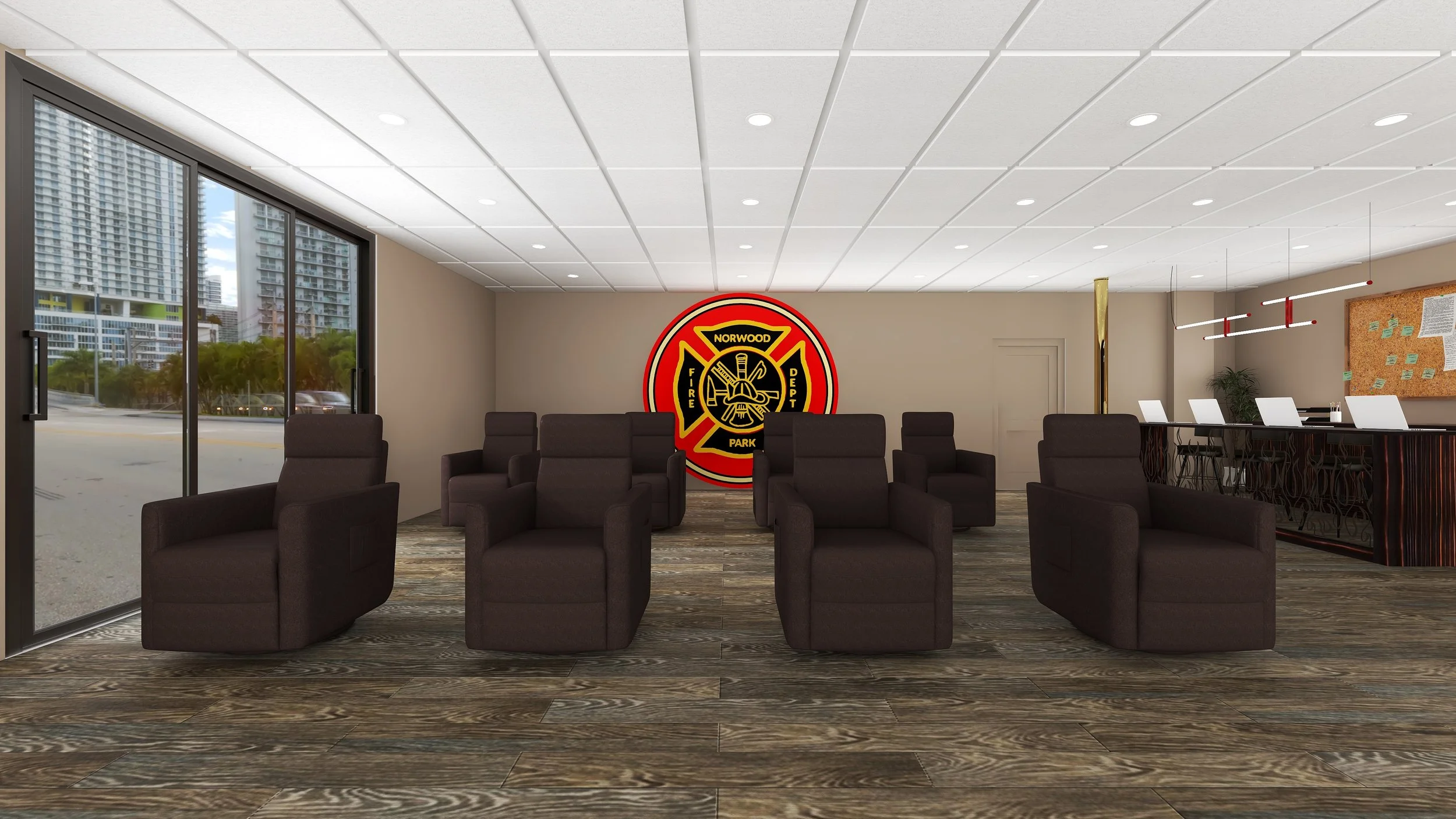 Interior of a fire department lounge with brown chairs arranged in a circle, large windows showing city buildings outside, a fire department emblem on the wall, and a cork bulletin board with notices.