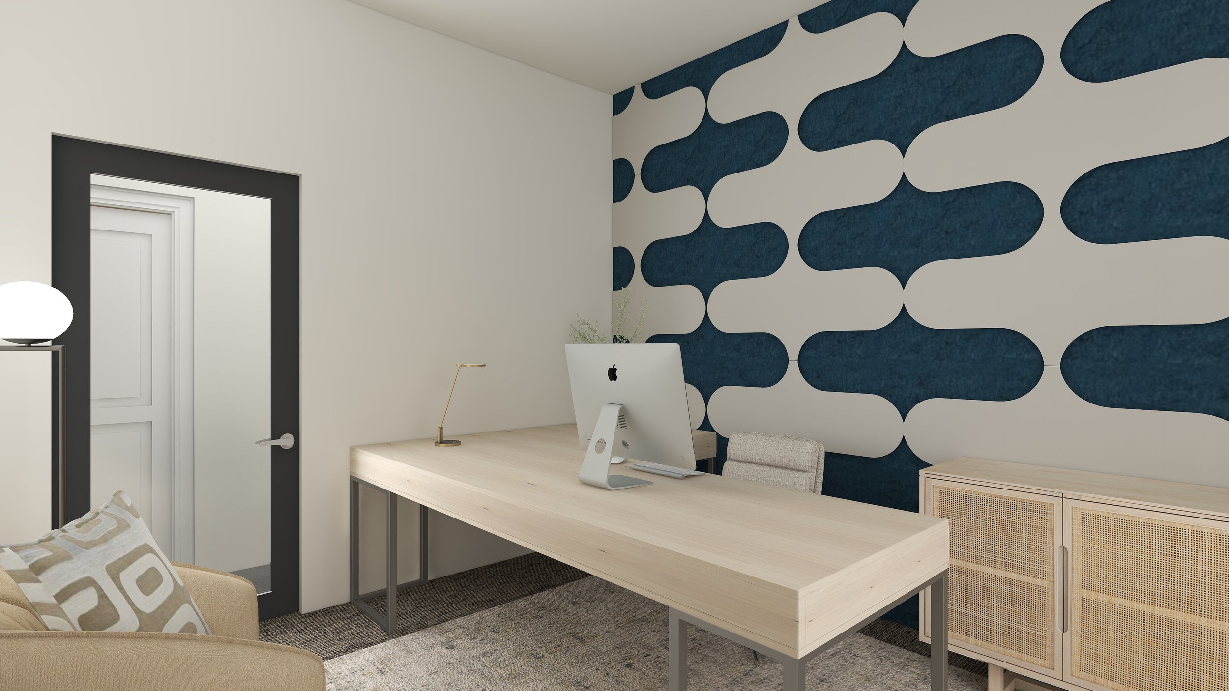 Modern home office with a light wooden desk, beige chair, white computer, gold desk lamp, and a rattan cabinet against a blue and white patterned accent wall.