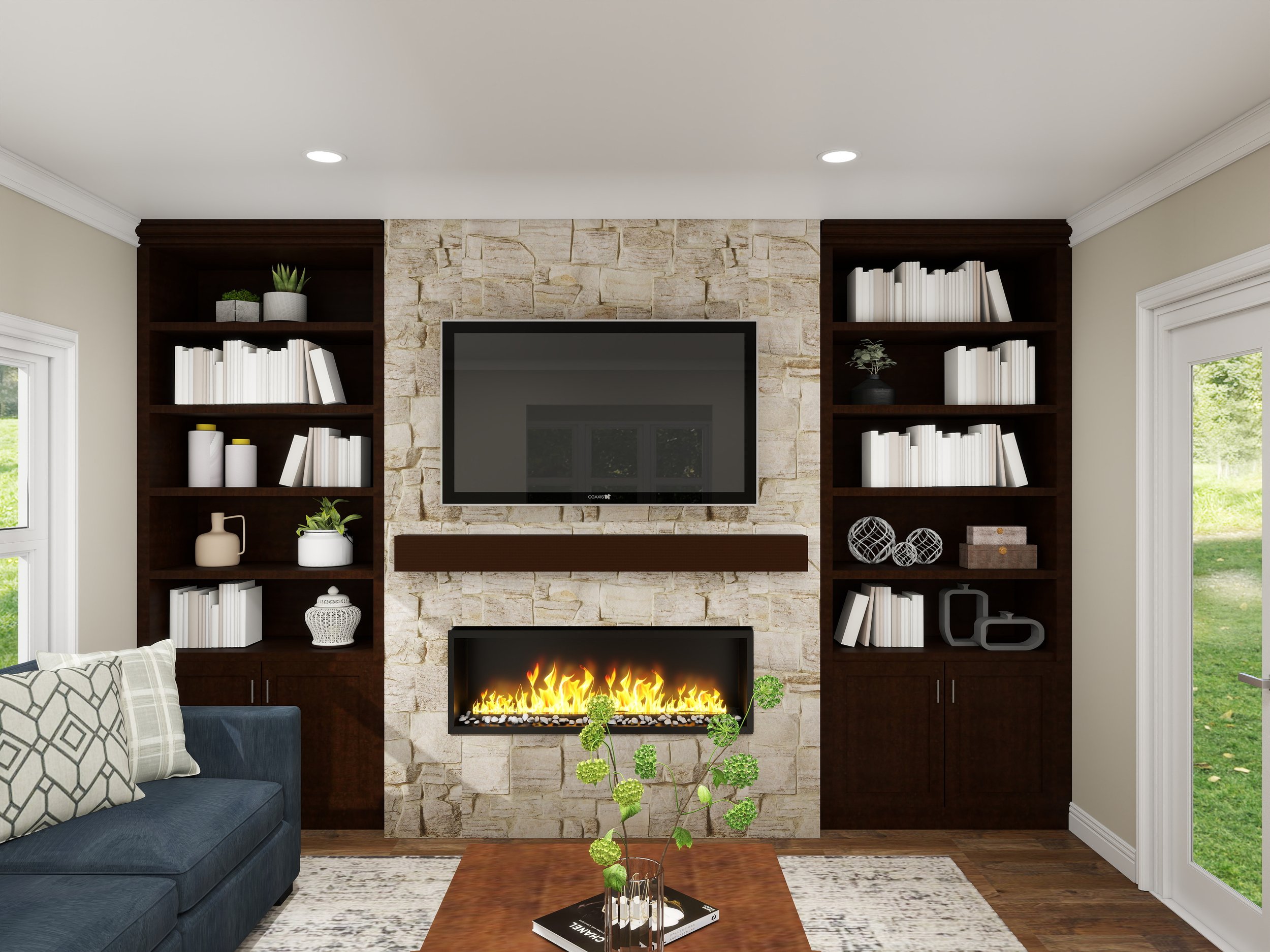 Living room with dark wood built-in shelves, a stone fireplace with a fire, a wall-mounted TV above the fireplace, a gray sofa with patterned pillows, a wooden coffee table with a plant and books, and windows showing greenery outside.