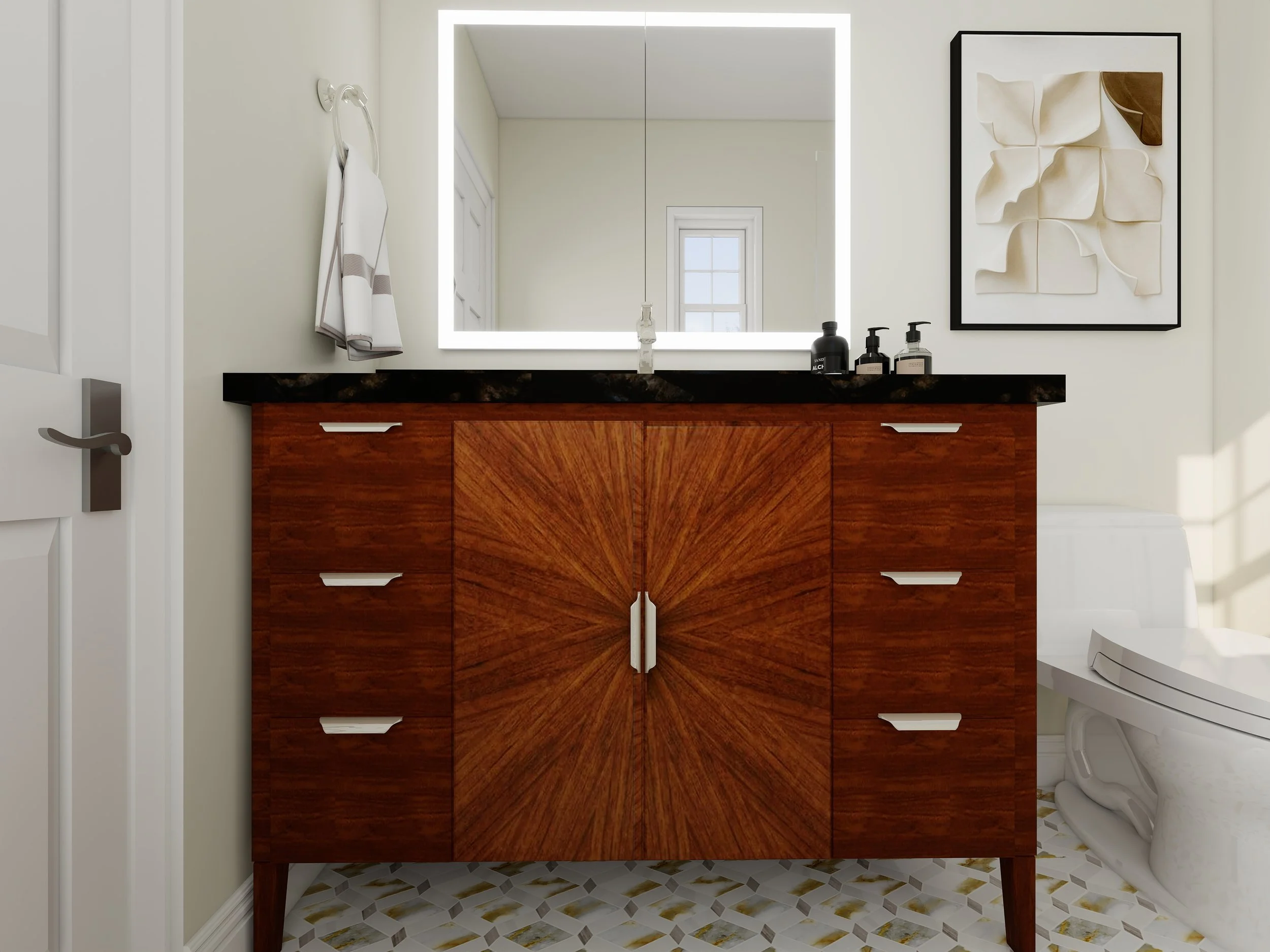A bathroom vanity with a dark marble top, a large backlit mirror, and a wooden cabinet with a sunburst pattern on the doors. There are soap dispensers on the counter, a towel hanging on a hook, and a small window reflected in the mirror.