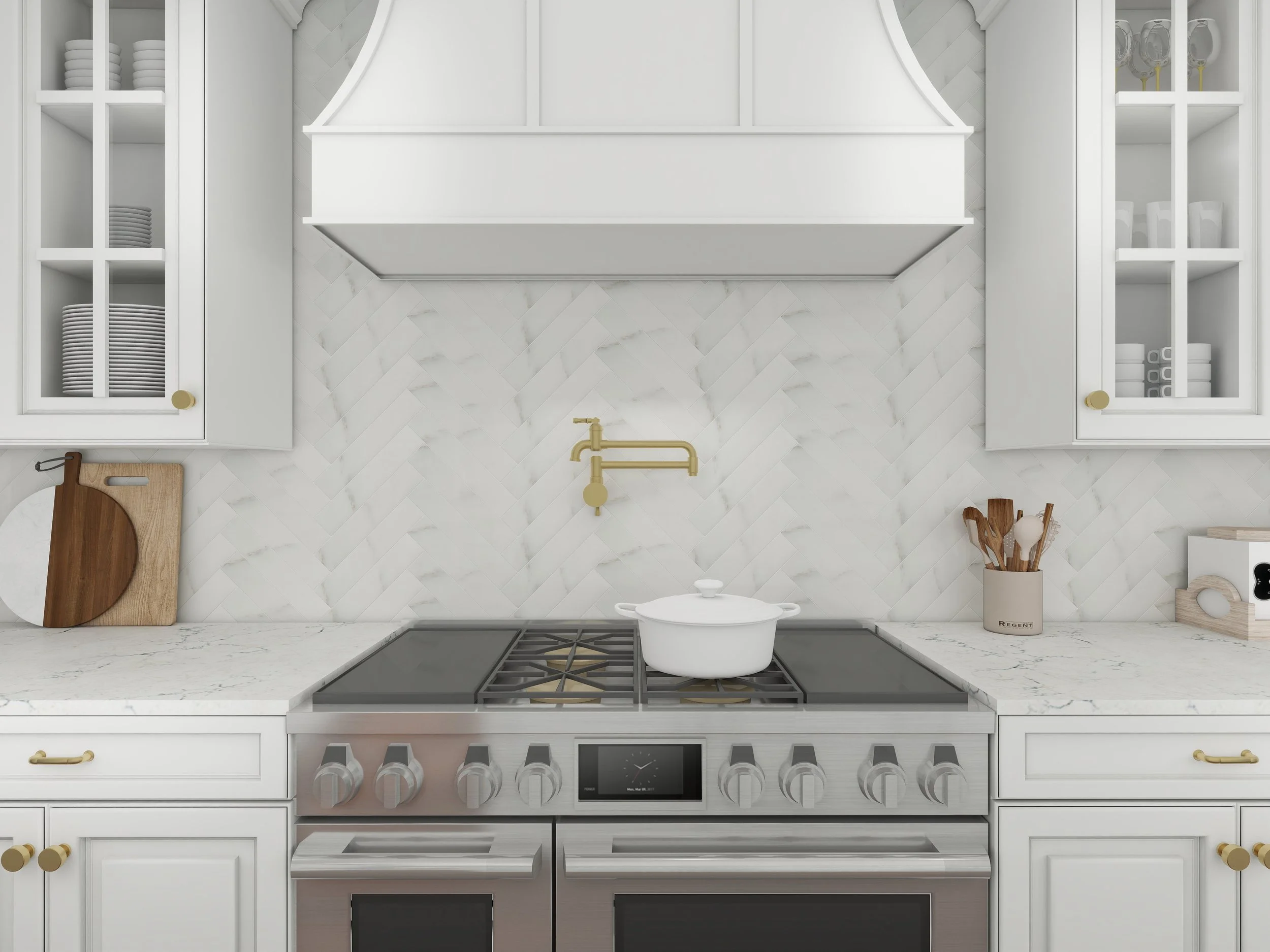 Top-down view of a modern white kitchen with a marble countertop, white cabinetry with gold handles, a stove, a white pot on the stove, a gold faucet, a wooden cutting board, and kitchen utensils in a white vase.