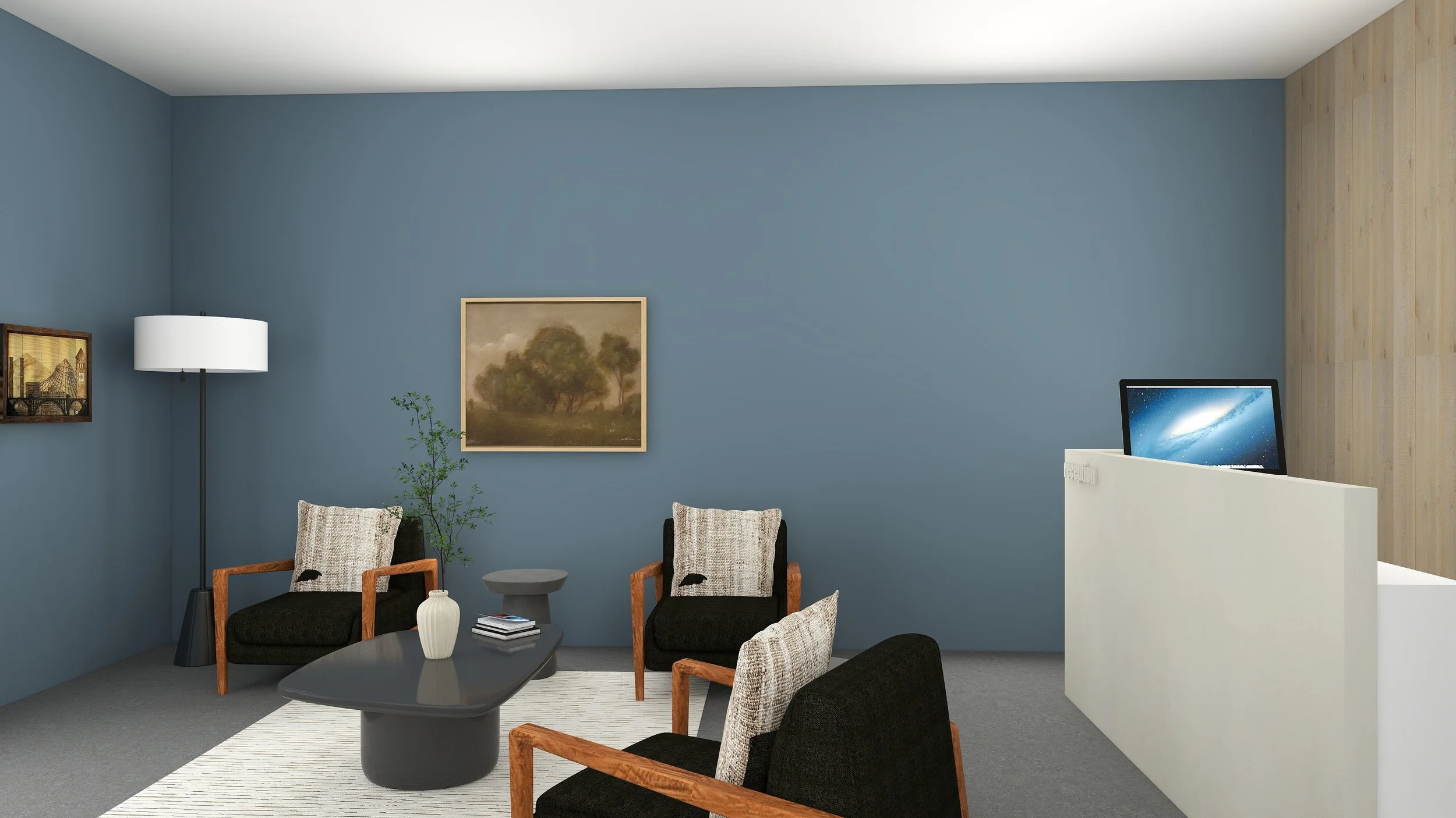 Living room with blue wall, framed artwork, floor lamp, black chairs with beige pillows, small side table, white ribbed vase, and a computer on a white divider.