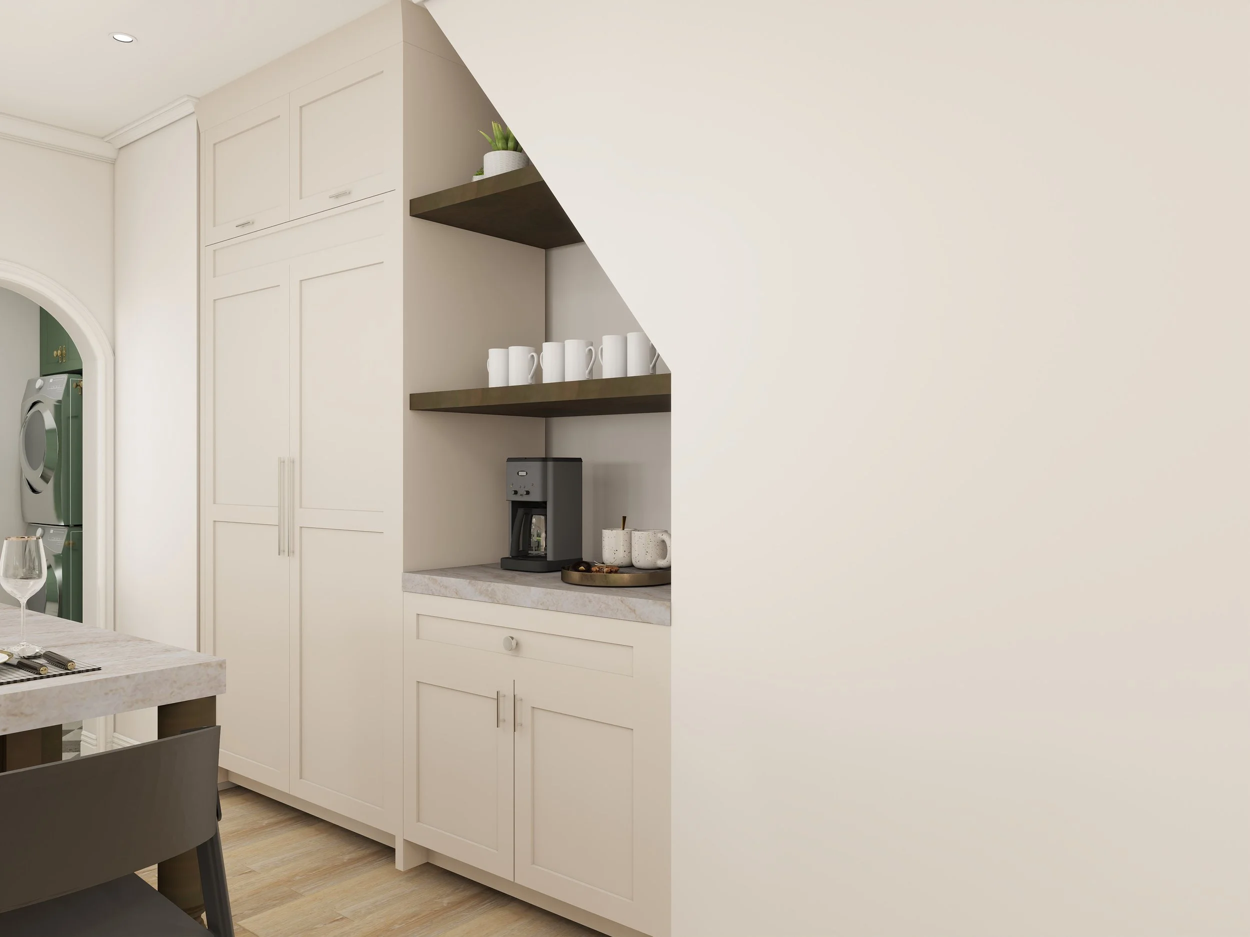 Modern kitchen with white cabinets, open shelves holding white mugs and a small plant, coffee maker on the countertop, and a partial view of a dining area with a glass of wine.