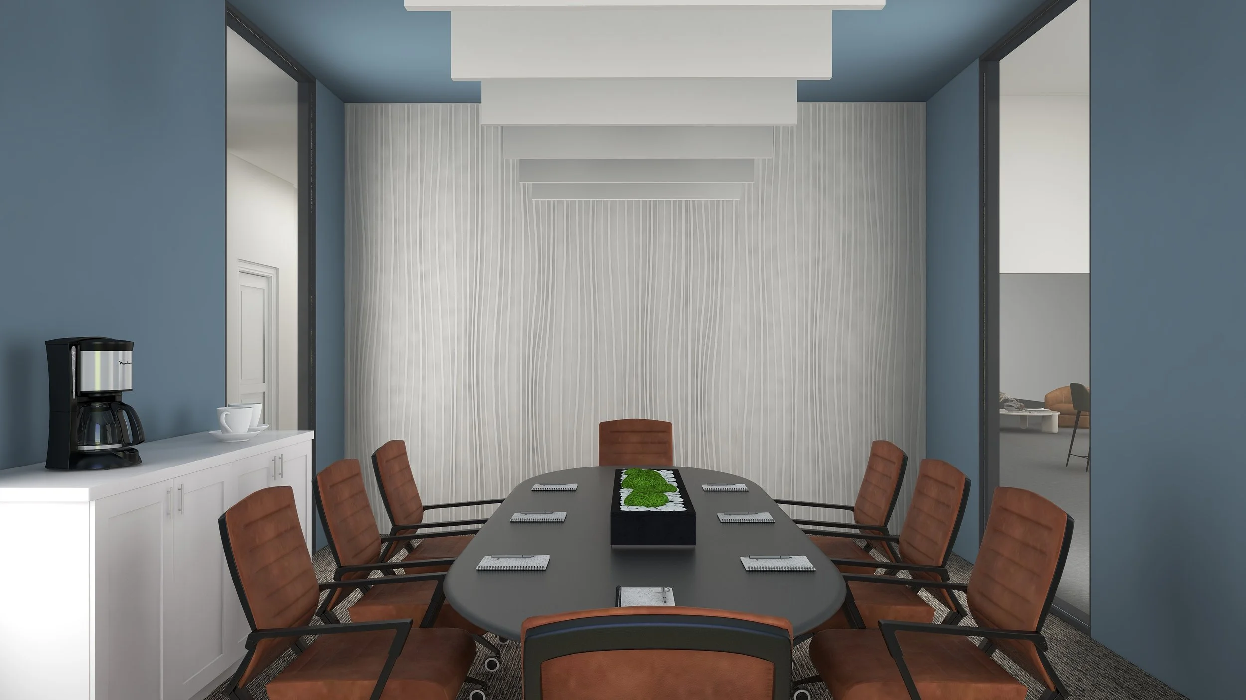 A conference room with a long black table surrounded by brown chairs, a white cabinet with a coffee maker and cups, and a textured white wall with a ceiling design. There are two doorways, one showing a glimpse of another room with seating.
