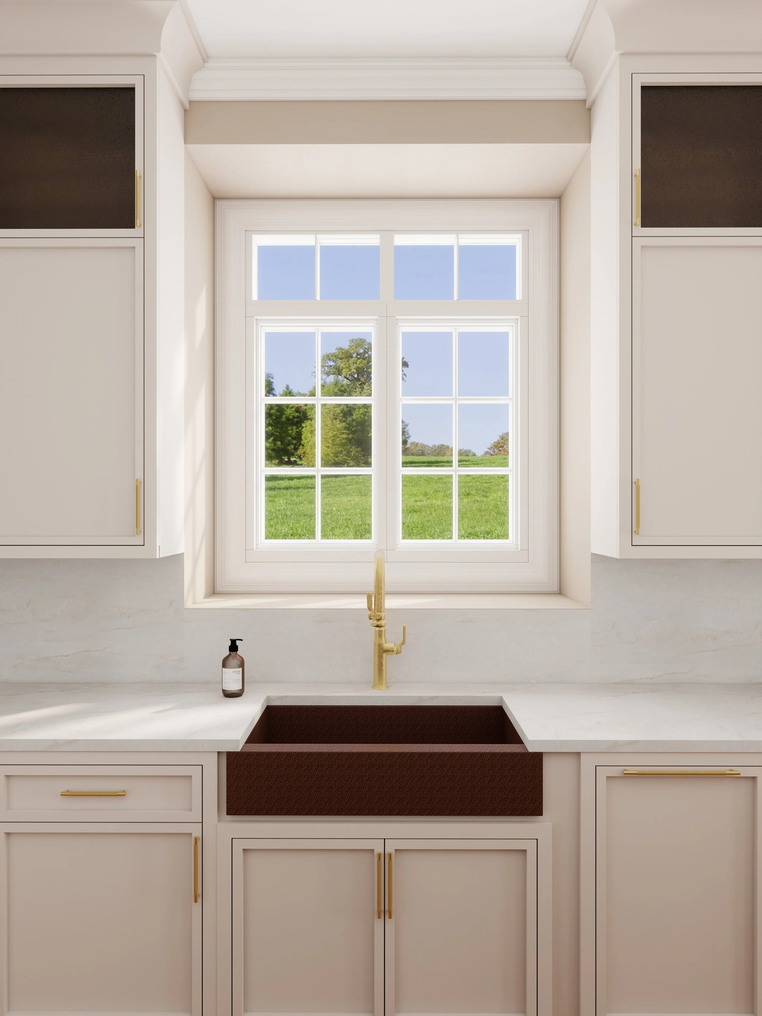 A kitchen view through a window showing a lush green landscape with trees and blue sky, with a beige countertop, a gold faucet, and a bottle of soap or lotion.