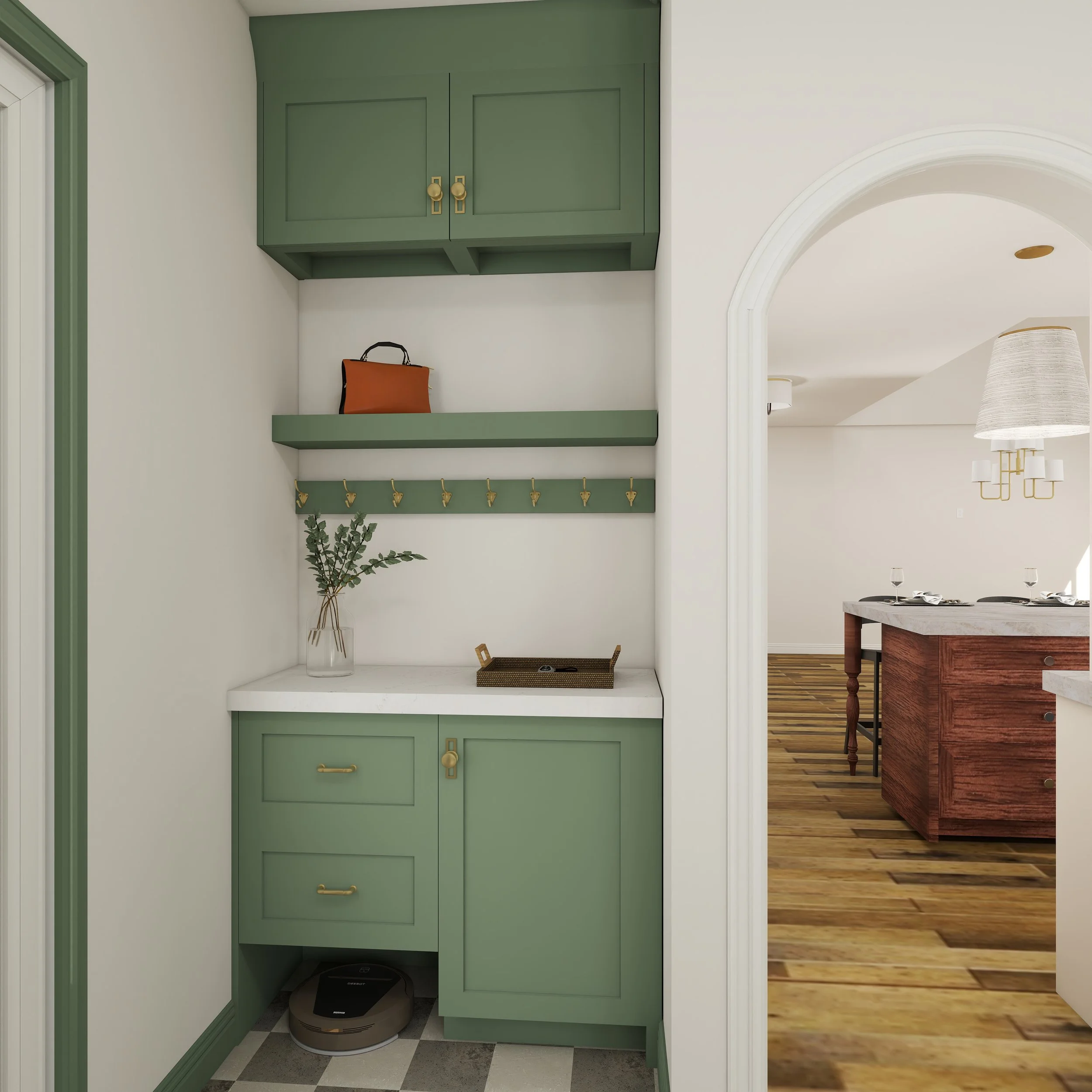 A small closet or storage nook with green cabinets, a shelf with gold hooks, and a wooden basket on the floor, adjacent to a white wall and doorway with green trim. A robotic vacuum is on the floor.