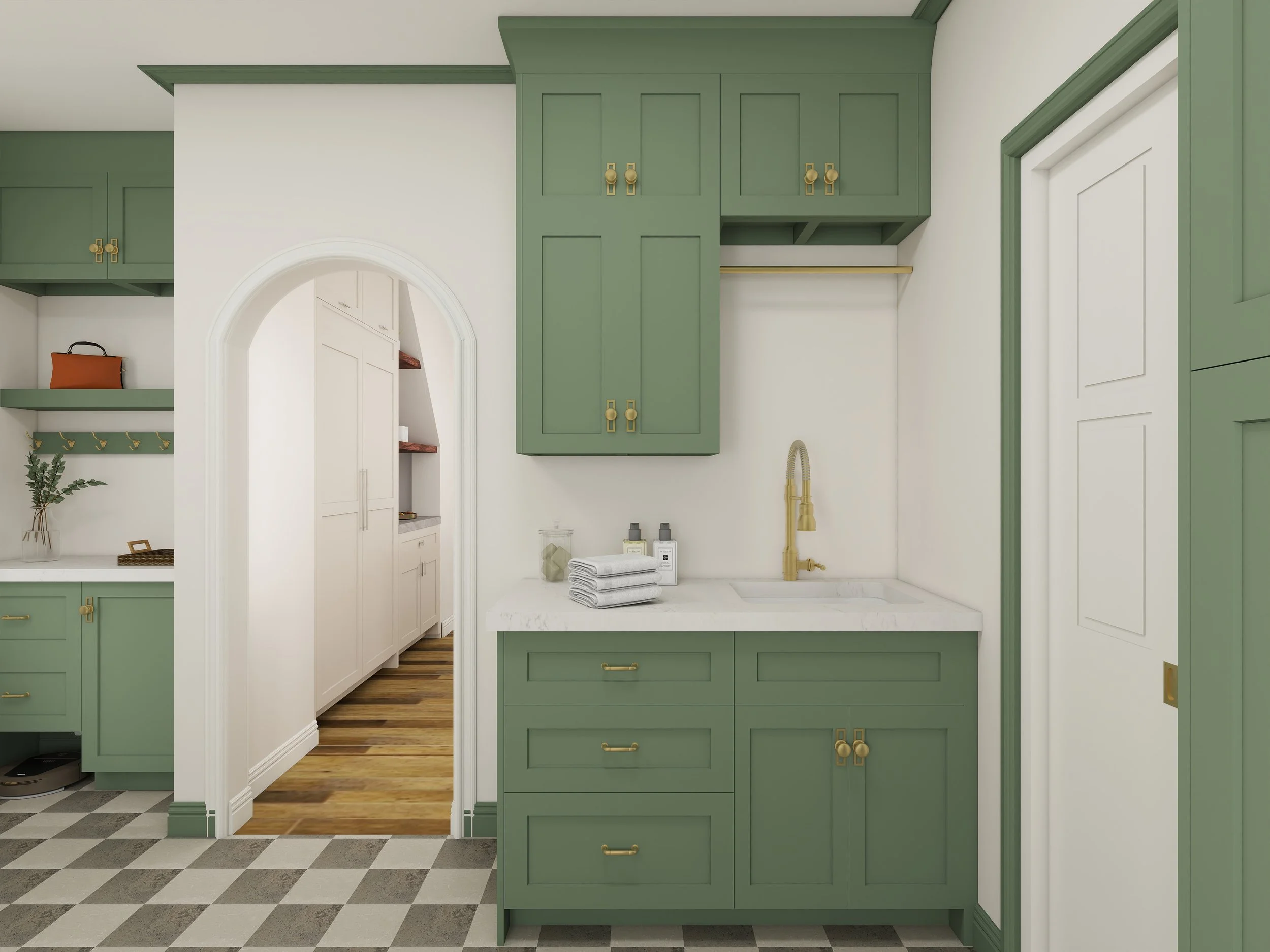 A kitchen with green cabinetry, gold handles, a white marble countertop, a gold faucet, towels, and toiletries on the counter, with a white door in the background and a black and white checkered floor.