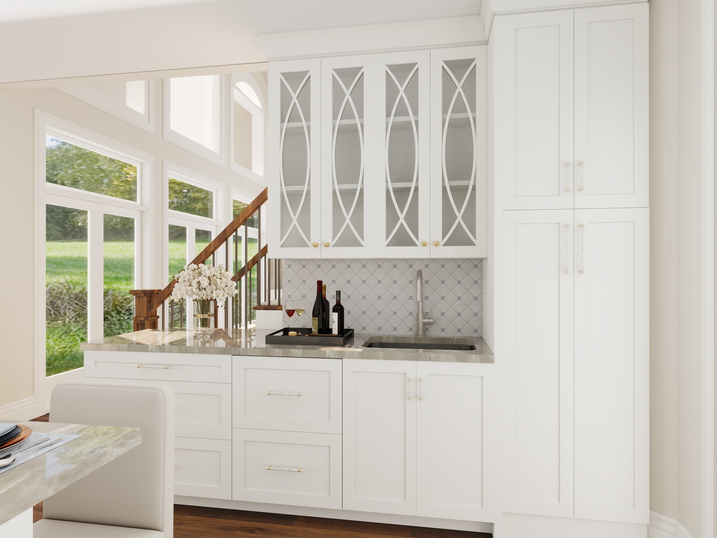 White kitchen with large windows, white cabinets, a small countertop with wine bottles and glasses, and a floral arrangement on a table.