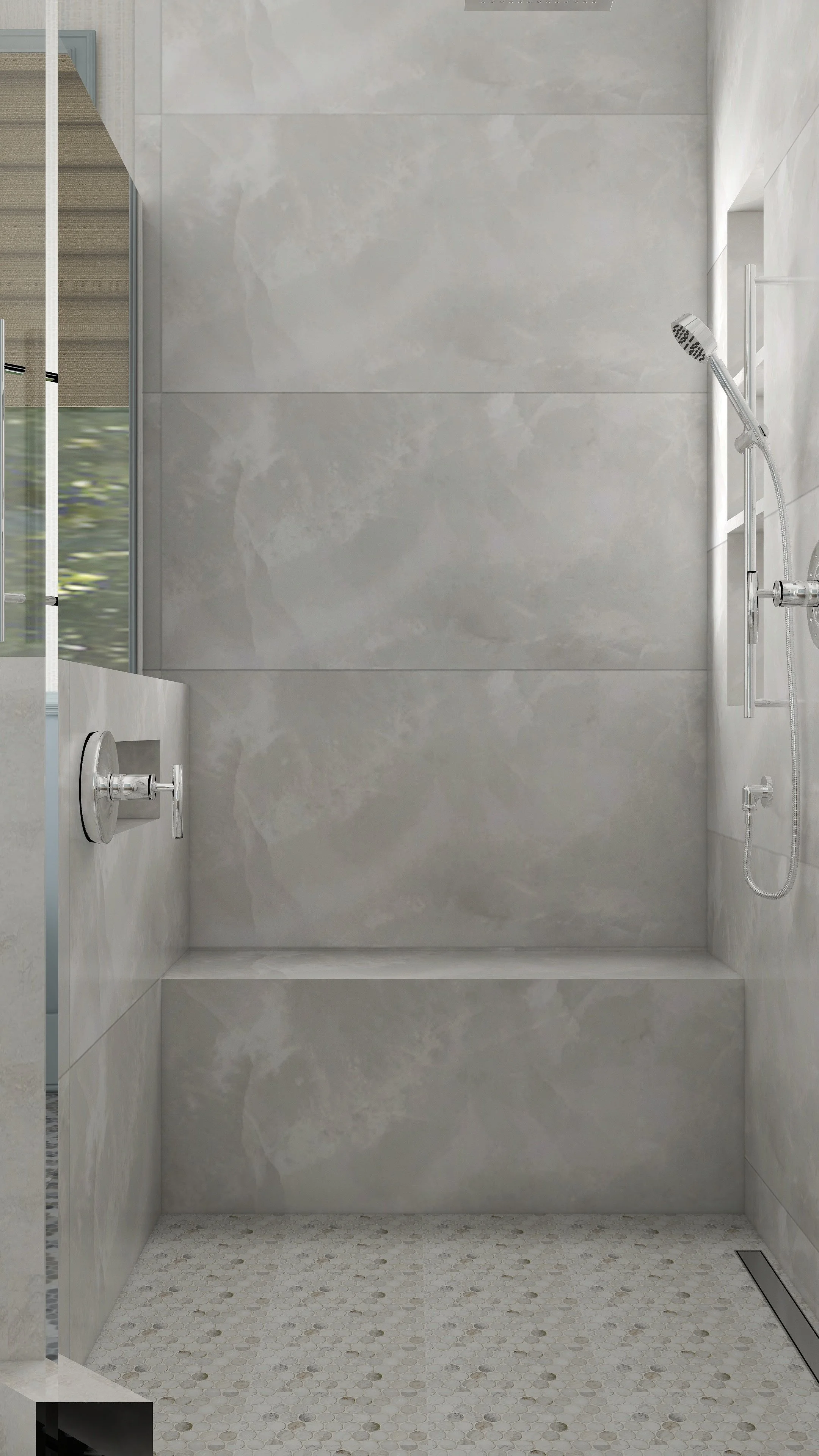 Modern shower with large gray tiled walls, a handheld showerhead, and a floor with small white pebble tiles.