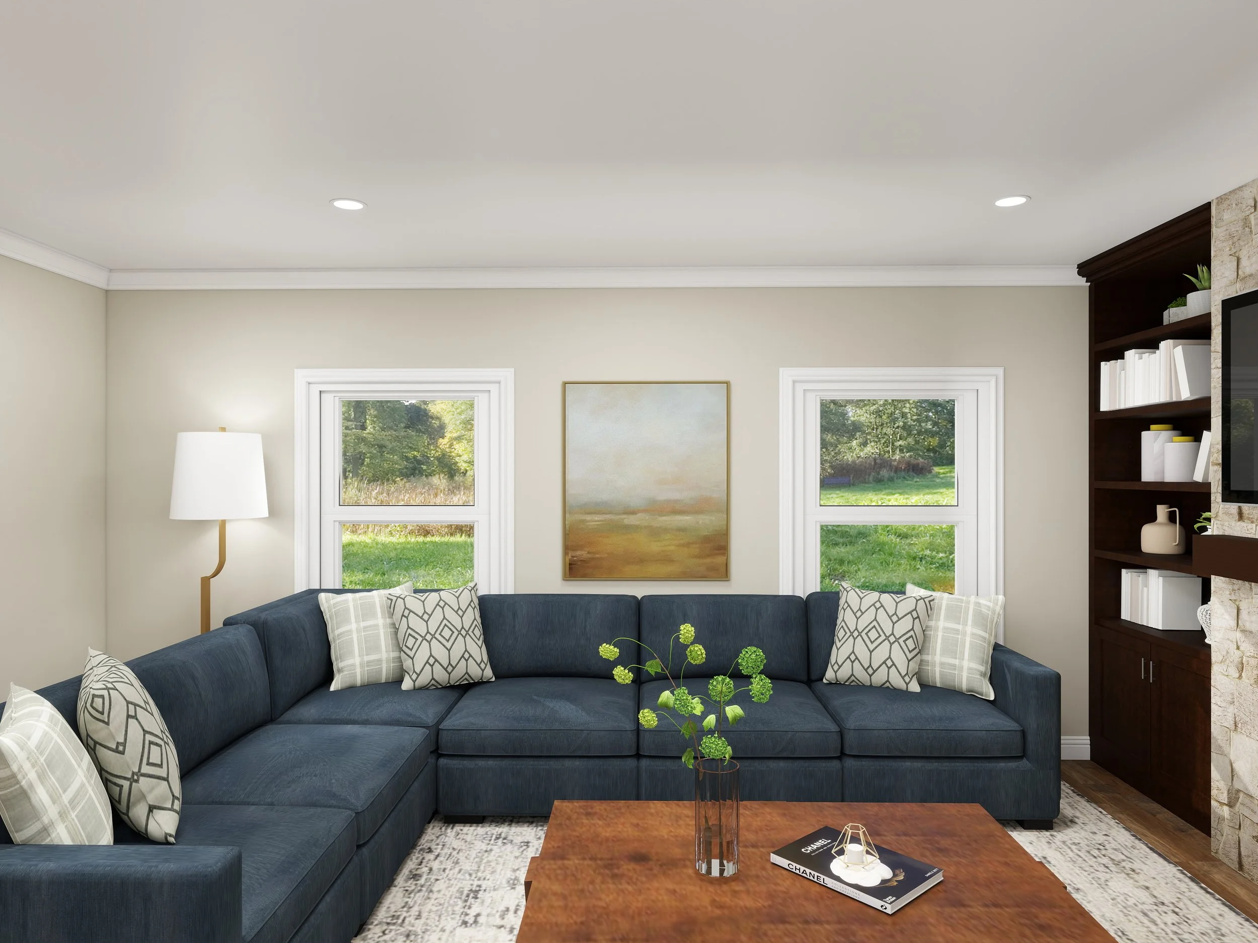 Living room with a navy blue sectional sofa, plaid pillows, a wooden coffee table with a green plant and books, a lamp, and large windows showing greenery outside.