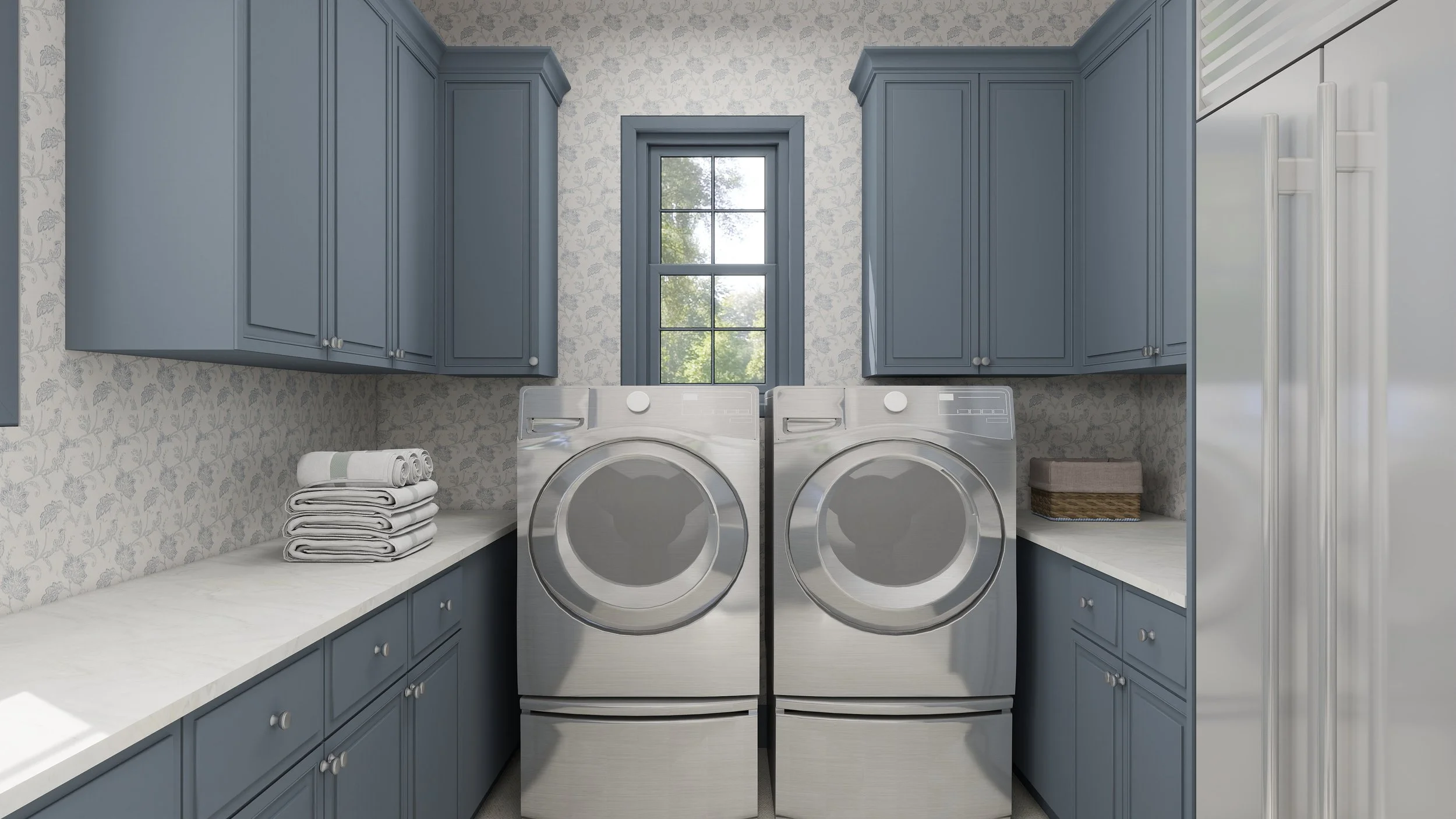 A laundry room with blue cabinets, a window, a washing machine, a dryer, and folded towels.