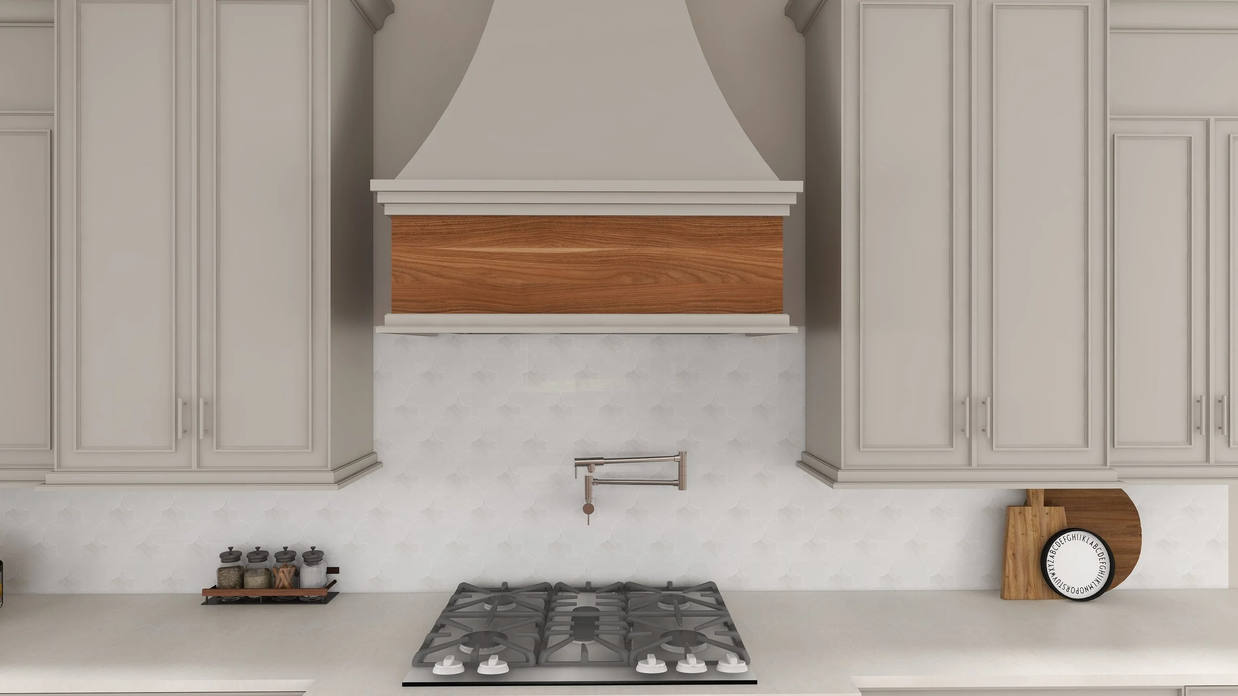 A modern kitchen with white cabinets, a gray range hood with a wooden accent underneath, a white tile backsplash, a stovetop, and small jars of spices on a wooden shelf.