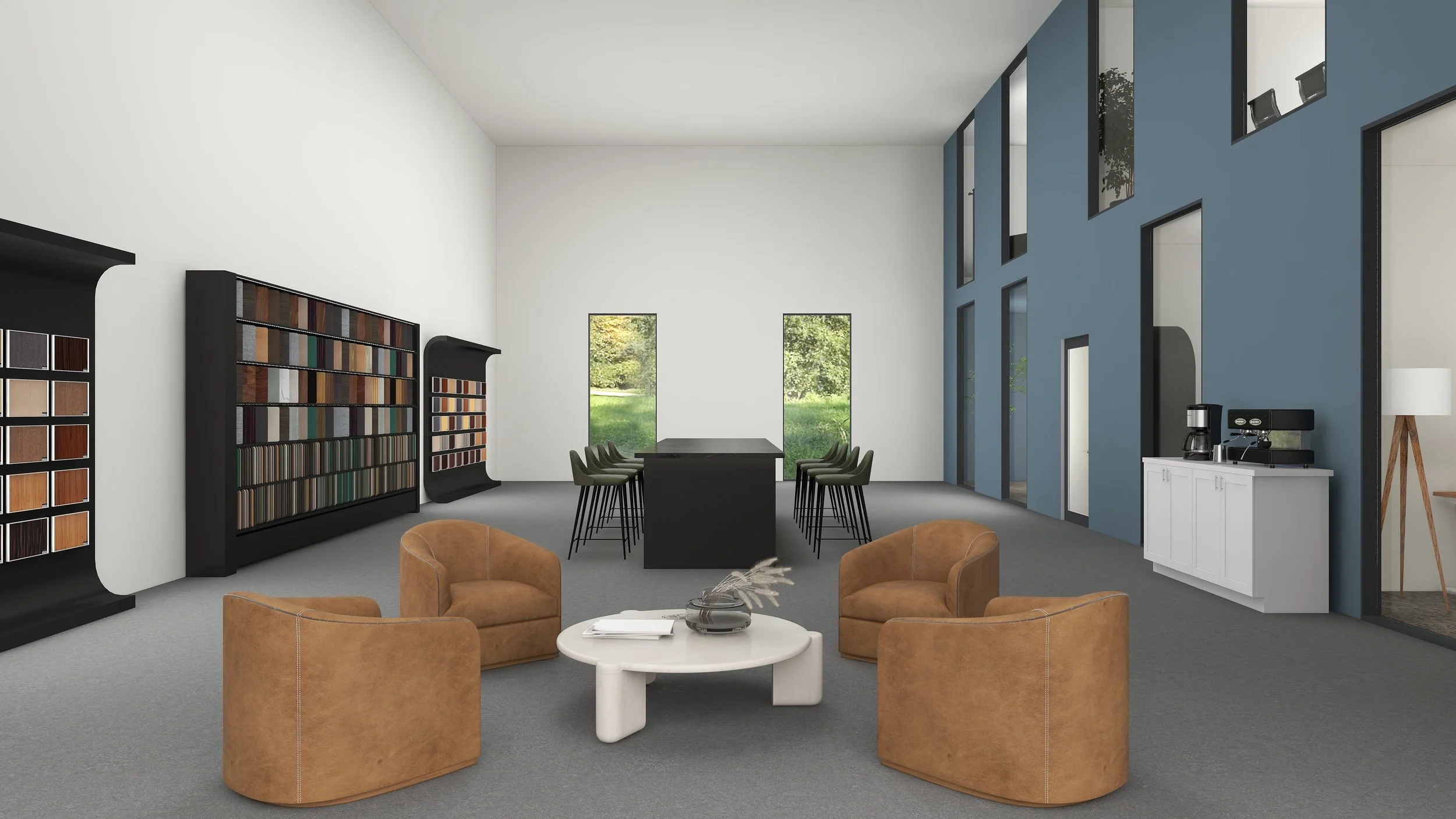 A modern meeting or lounge area with tan armchairs, a white coffee table, bookshelf samples on black display, a long table with green chairs, and windows showing outdoor greenery.