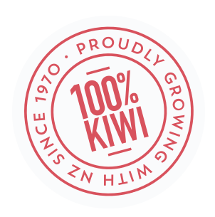 A circular logo with red text that reads '100% Kiwi' inside a red circle. The outer circle has the phrases 'Proudly Growing withNZ' and 'Since 1970' written in red.