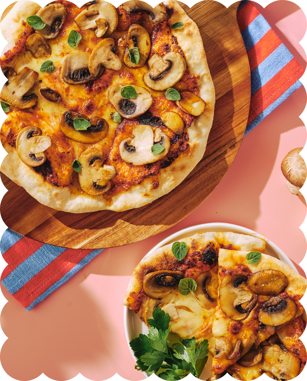 Pizza topped with mushrooms, cheese, and fresh herbs, served on a wooden board and a plate.