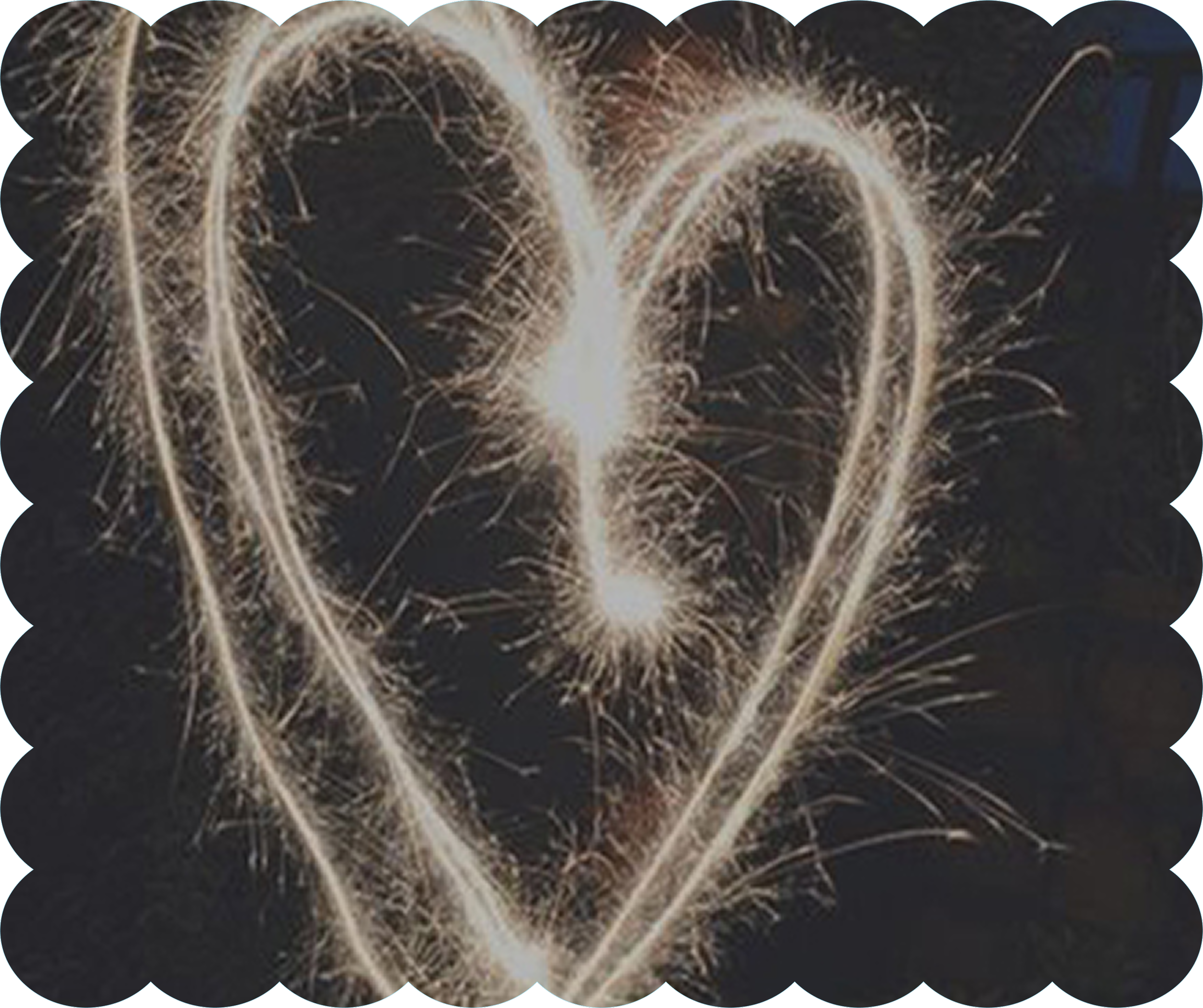 Fireworks exploding in a dark night sky, forming heart shapes.