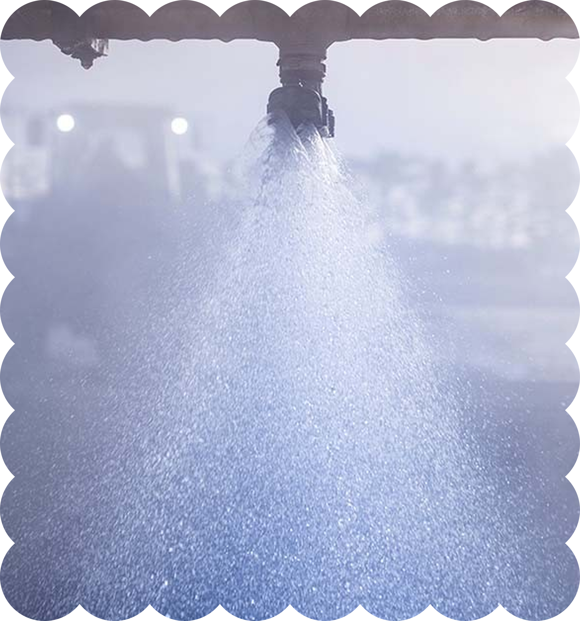 Water is spraying from a faucet onto a blue surface, creating a mist or spray.