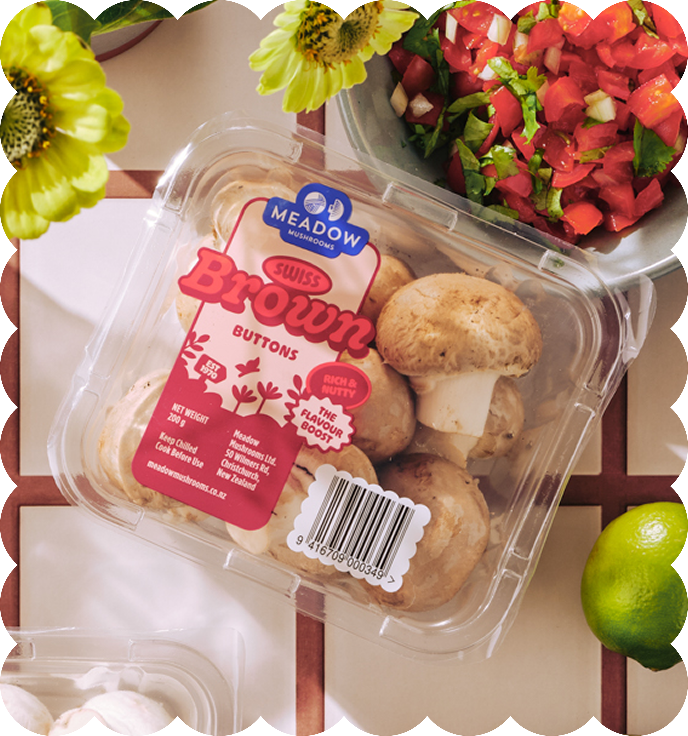 A plastic container of frozen chicken nuggets with a label reading 'Meadow Mushrooms' with a red and white design. The container is placed on a table next to a bowl of chopped red and green salad with onions, and fresh green apples are partially visible in the image.