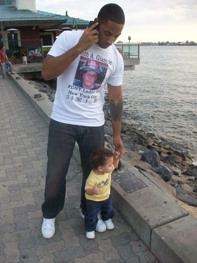 Father and child walking beside the water