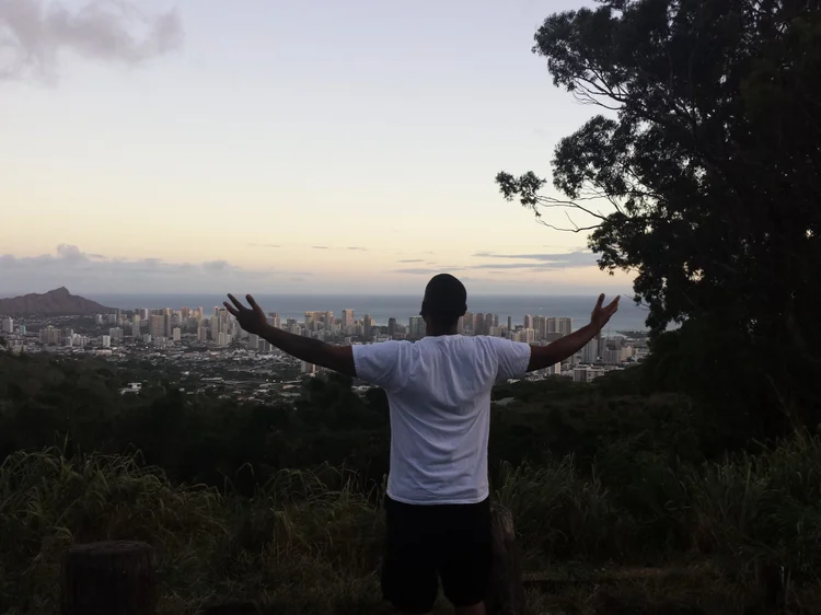 Arms open toward the sunset