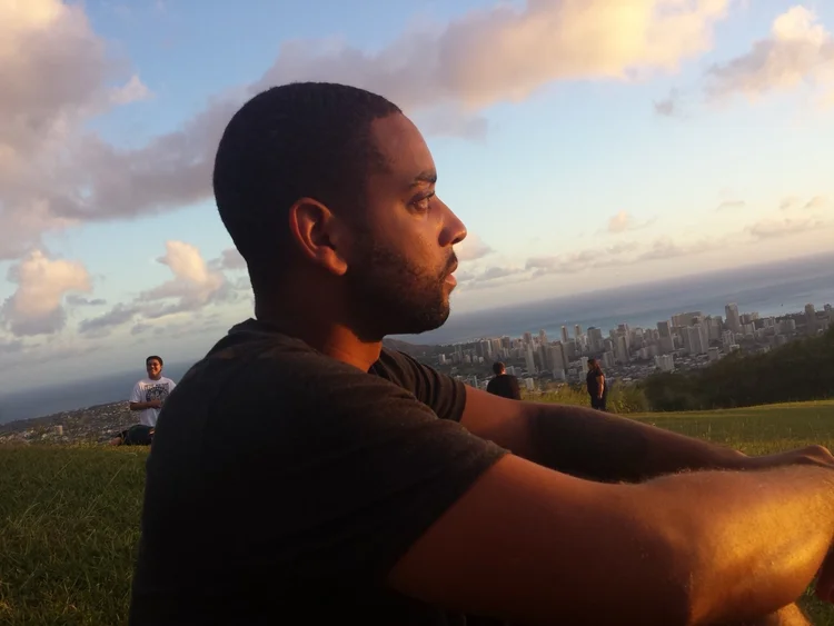 A quiet moment on a grassy hill at sunset
