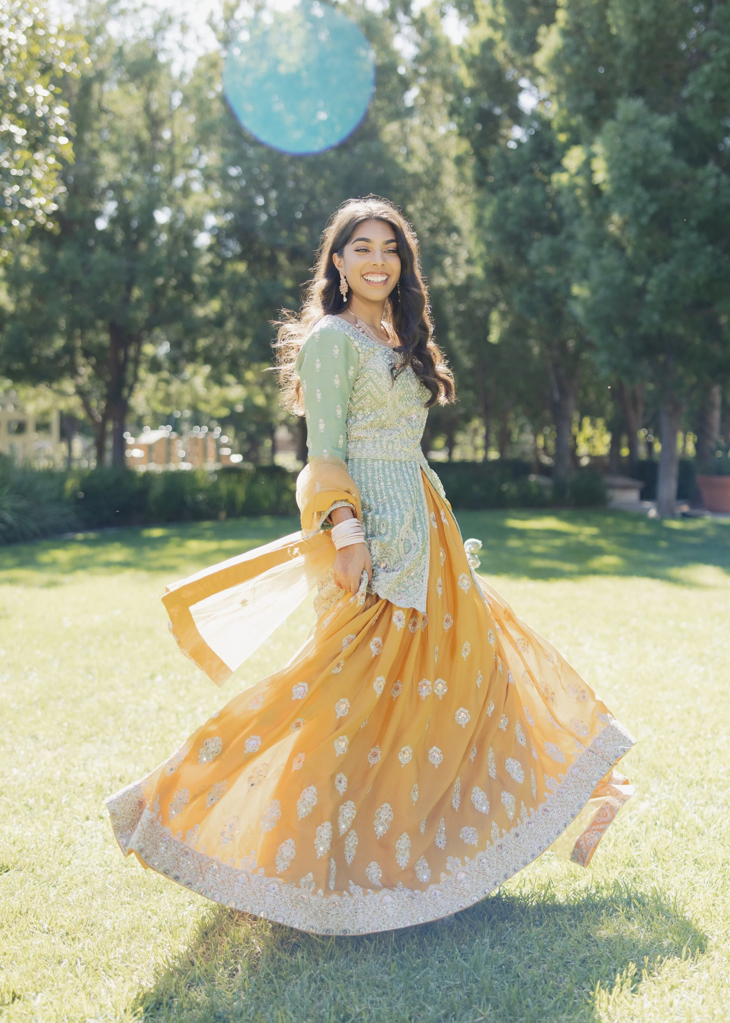  Bride in shimmering lehenga during evening sangeet performance 
