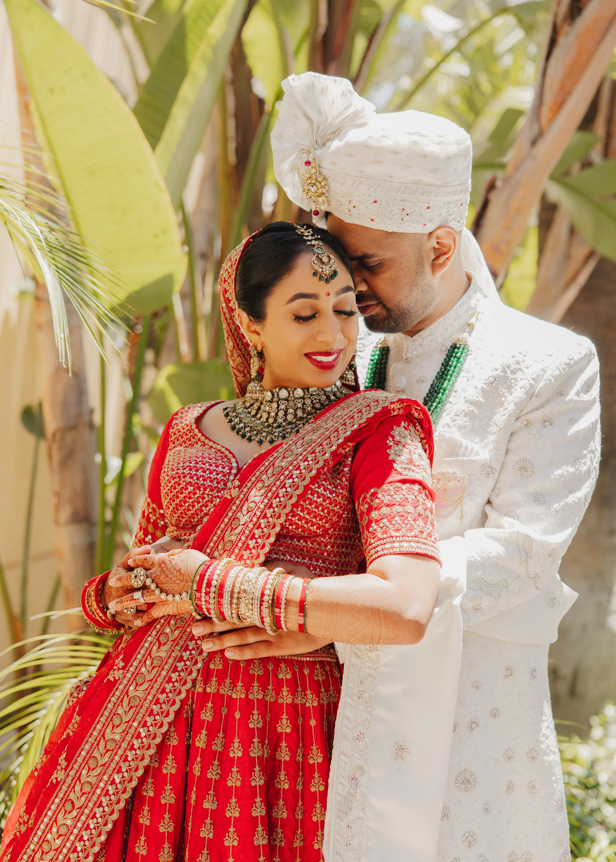  Bride in traditional red and gold wedding outfit during South Asian ceremony 