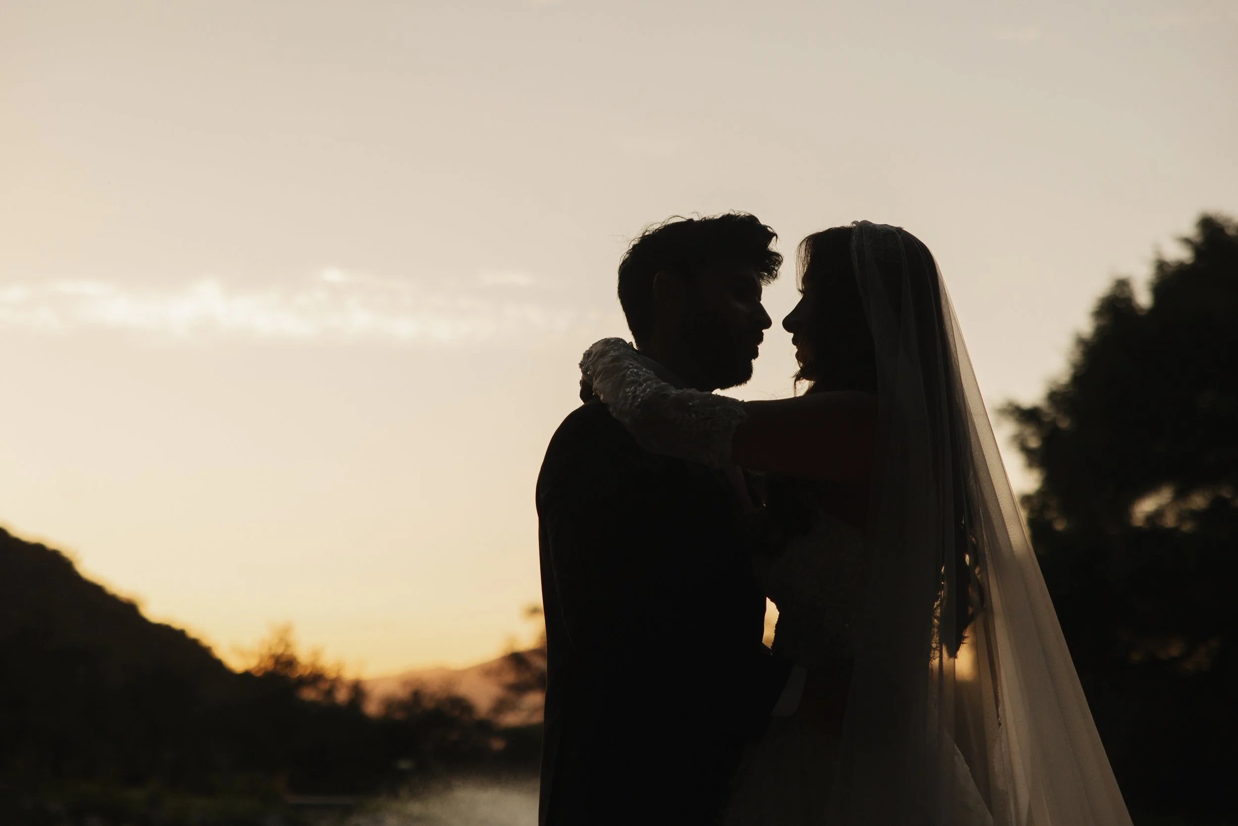 Silhouette of Juliana and Alishan embracing at sunset during their San Diego Pakistani-Mexican wedding
