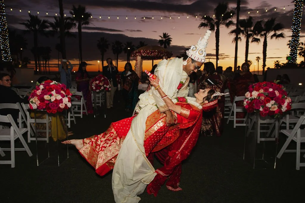 Romantic evening portrait of a South Asian bride and groom at The Waterfront Beach Resort at dusk