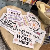 Set of colorful paper signs with messages about responsibility, confidence, and work in an office setting.