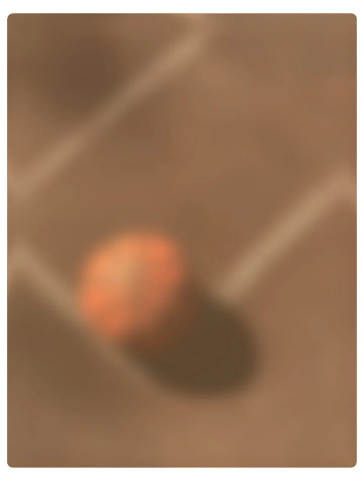Blurred image of a basketball on a basketball court