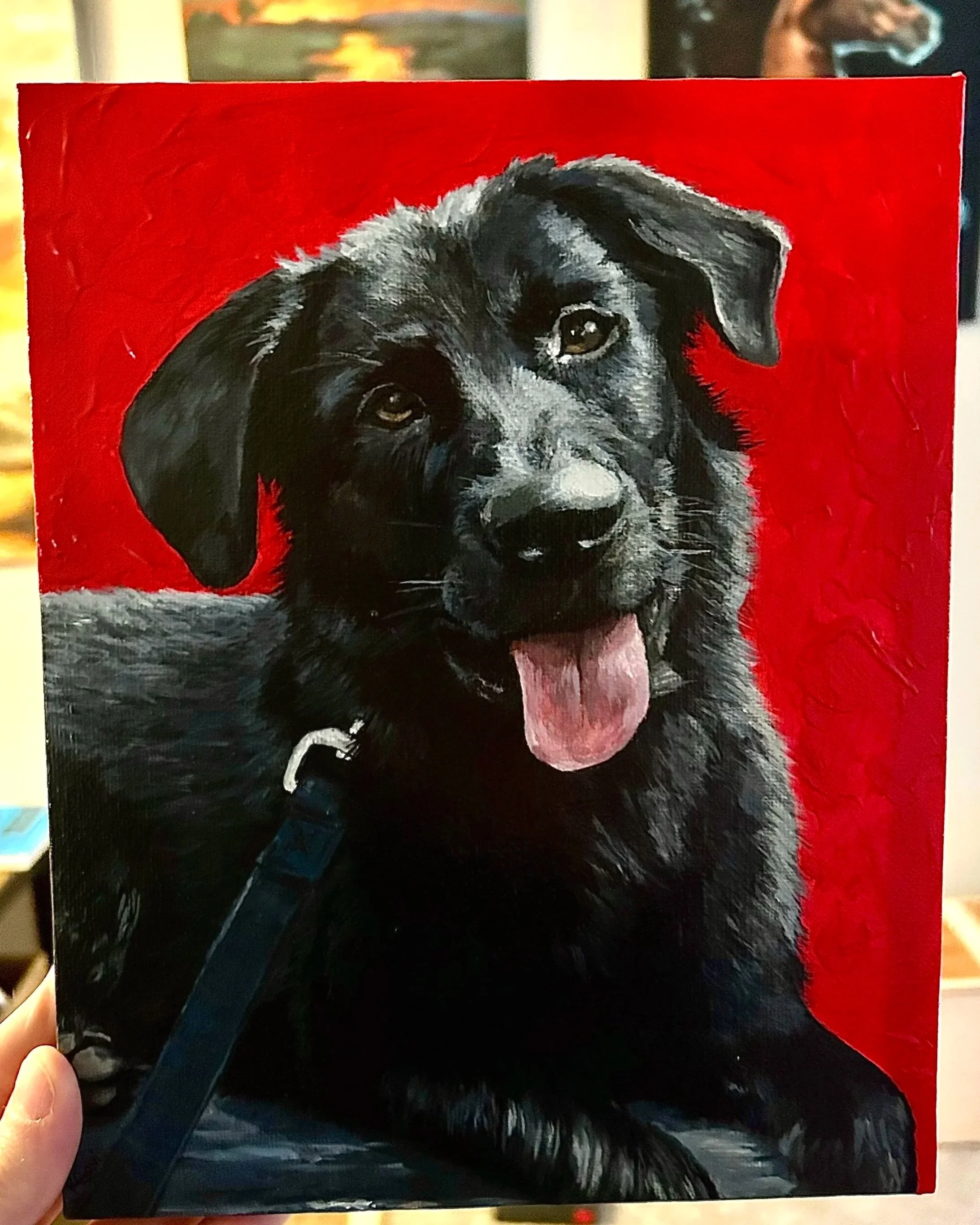 Painting of a black and gray dog with floppy ears and a pink tongue, set against a red background.
