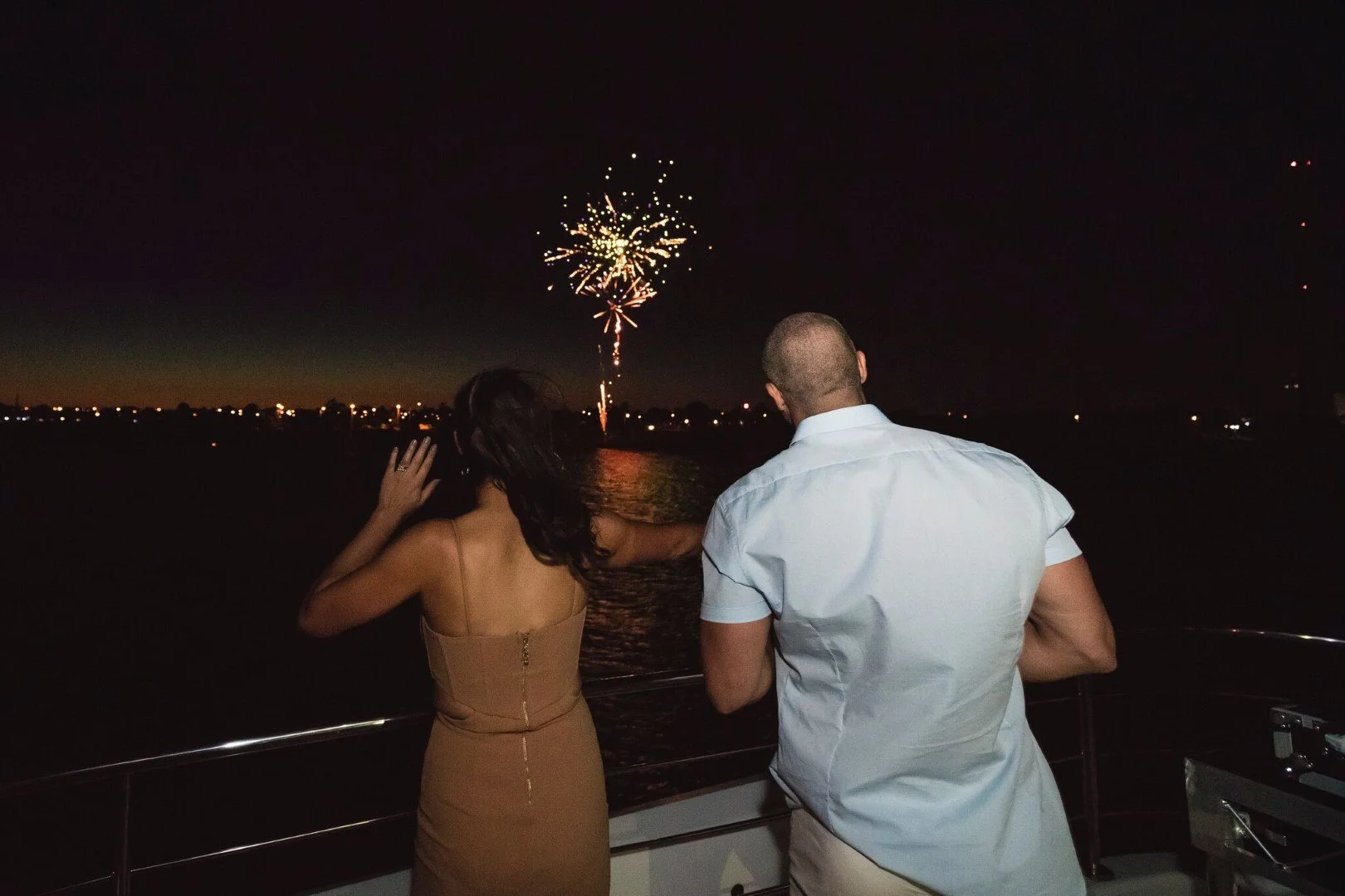 A couple on MV Pearl at night watching Melbourne's fireworks over the water.