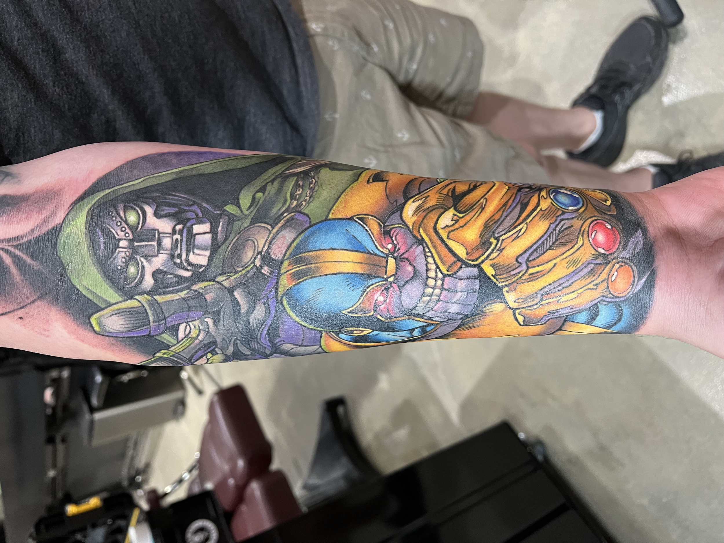 Forearm tattoo of Marvels Doctor Doom And Thanos. Artwork based off Marvel Comic books.