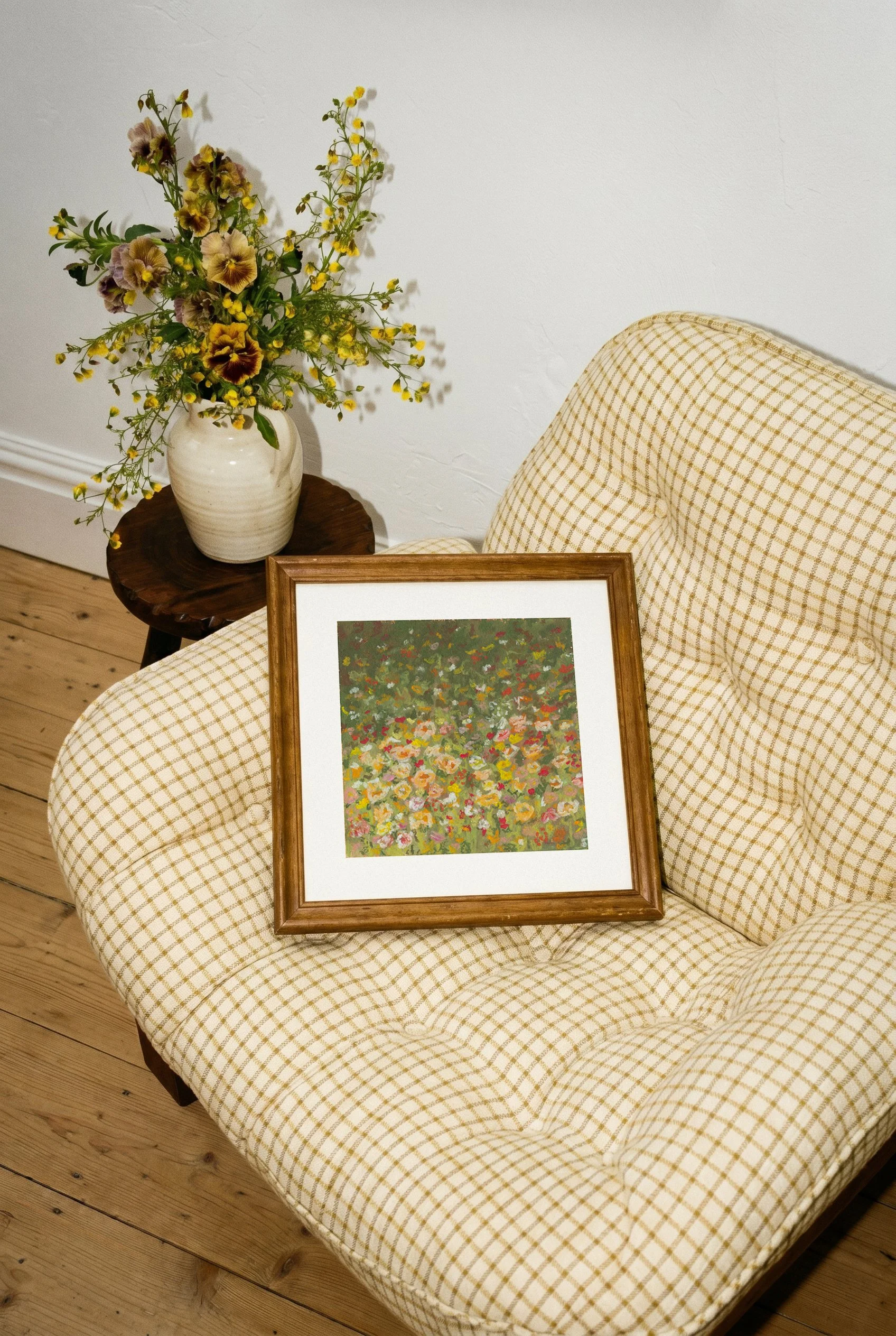 Melted Meadow framed art print resting on upholstered chair, abstract floral wall decor