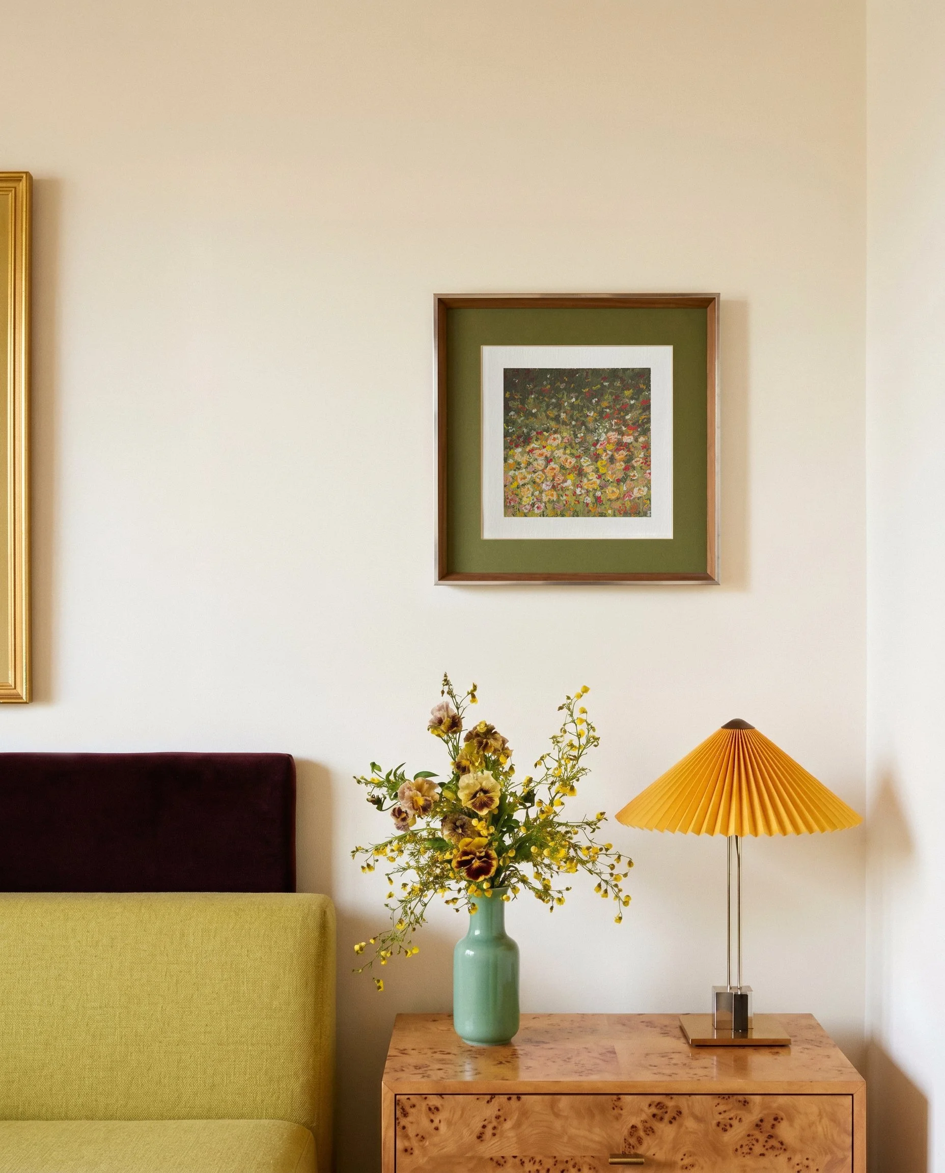 Melted Meadow framed oil pastel print displayed on wall above wooden side table