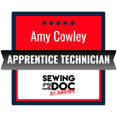 Name tag for Amy Cowley indicating she is an Apprentice Technician at Sewing Doc Academy, with red, black, white, and blue colors and five stars at the top.