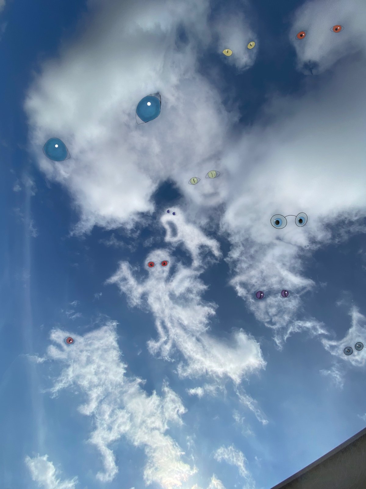 Sky with clouds and sunglasses lines, eyes, and faces drawn or edited onto the clouds.
