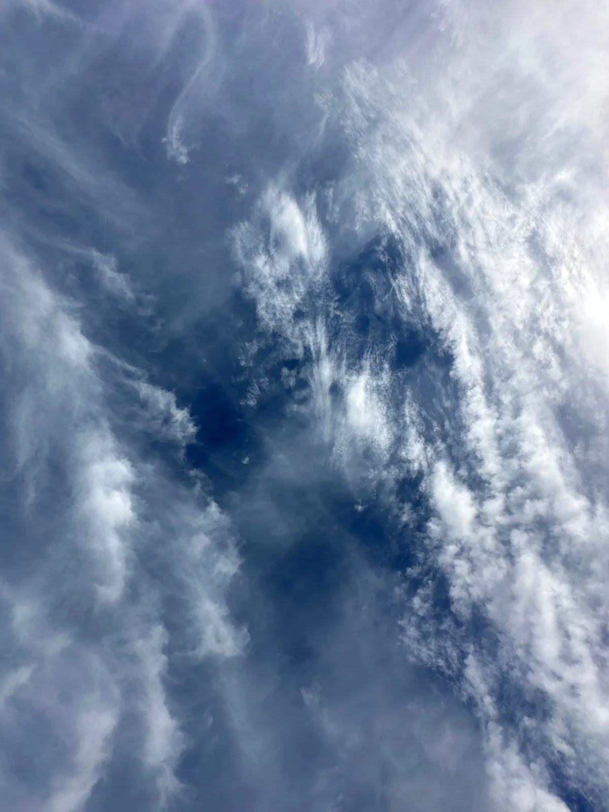 Blue sky with scattered white clouds.