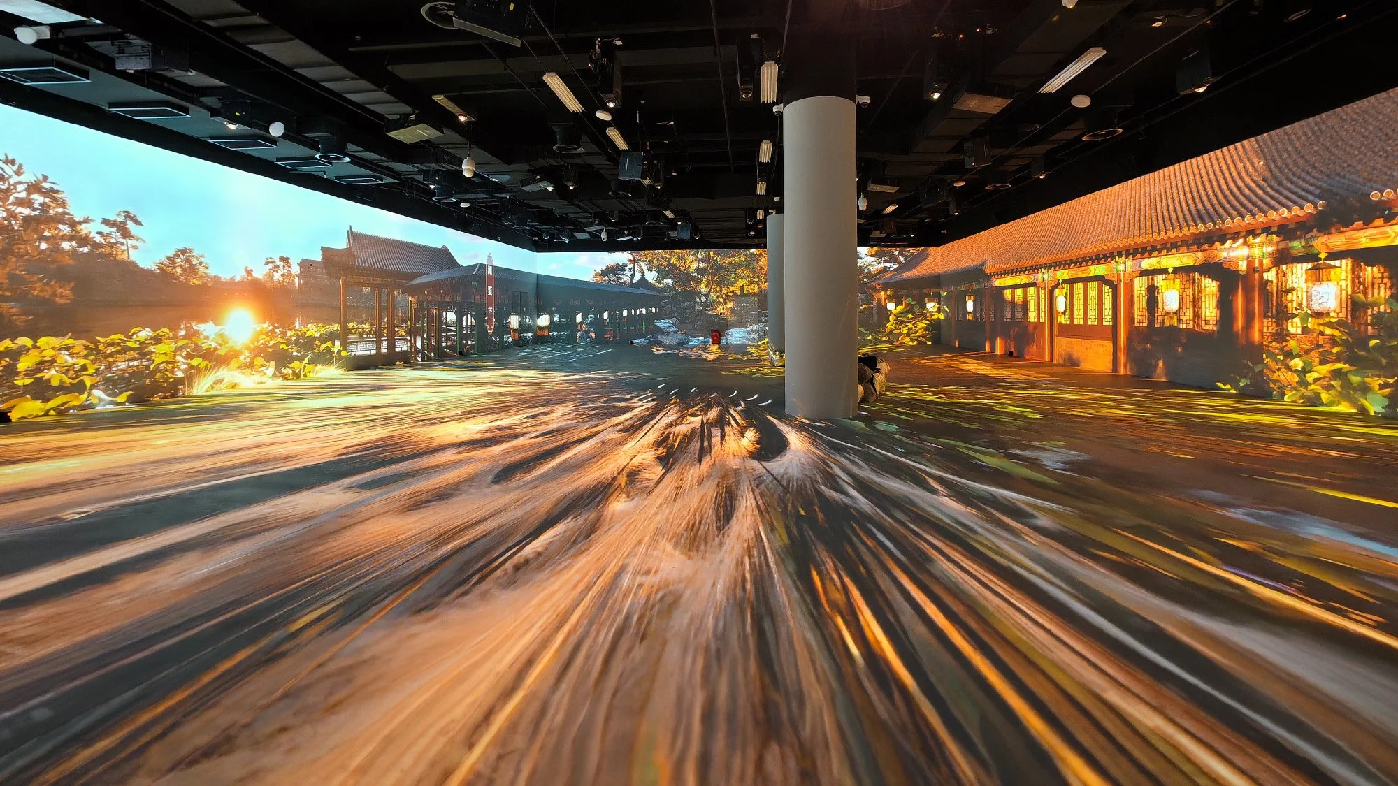 "Three Hills and Five Gardens" exhibit in Beijing: Immersive digital display of Asian temple at sunrise with motion blur.