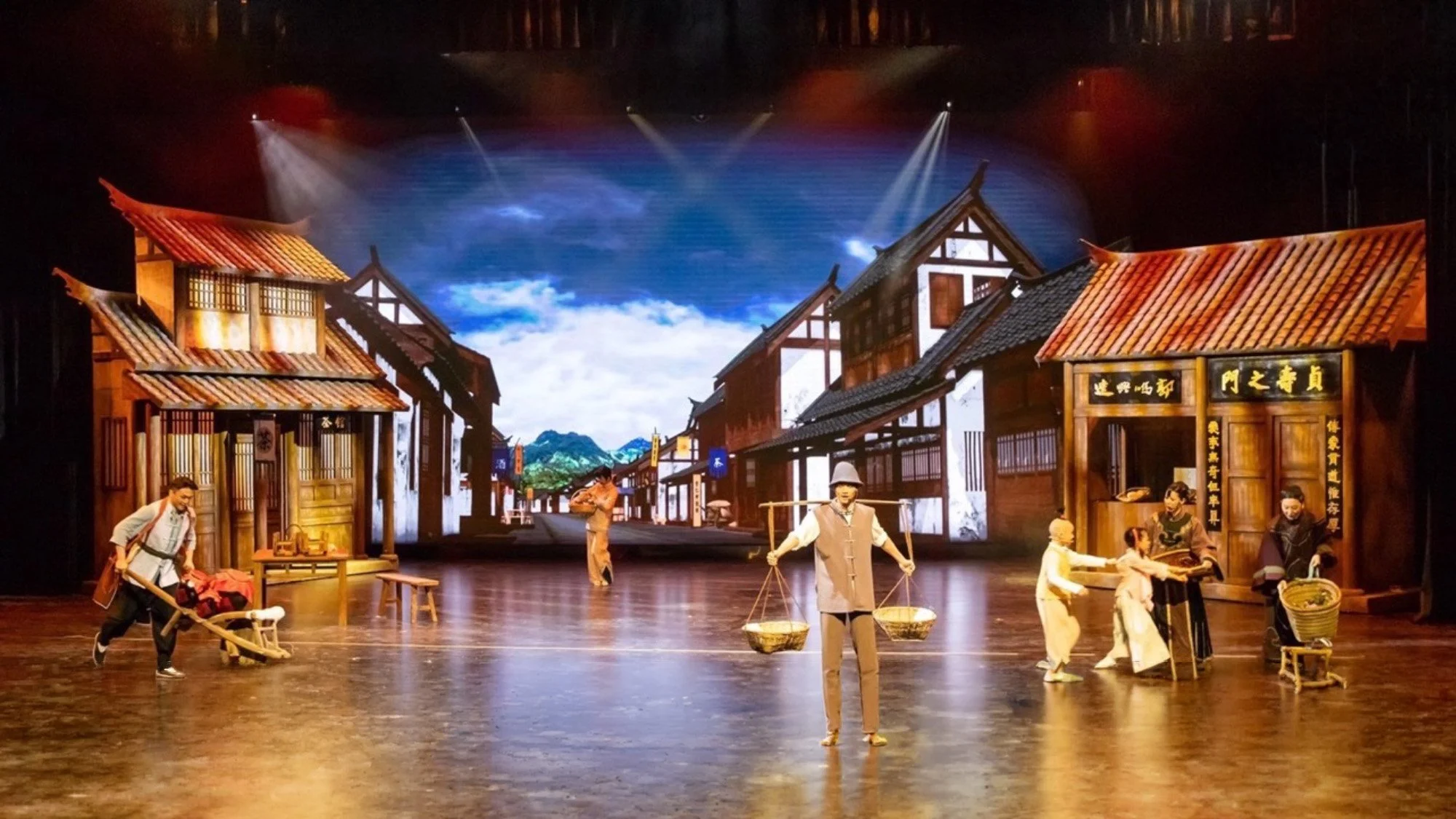 Traditional village play with costumed actors on stage at Moruo Theater in Leshan.