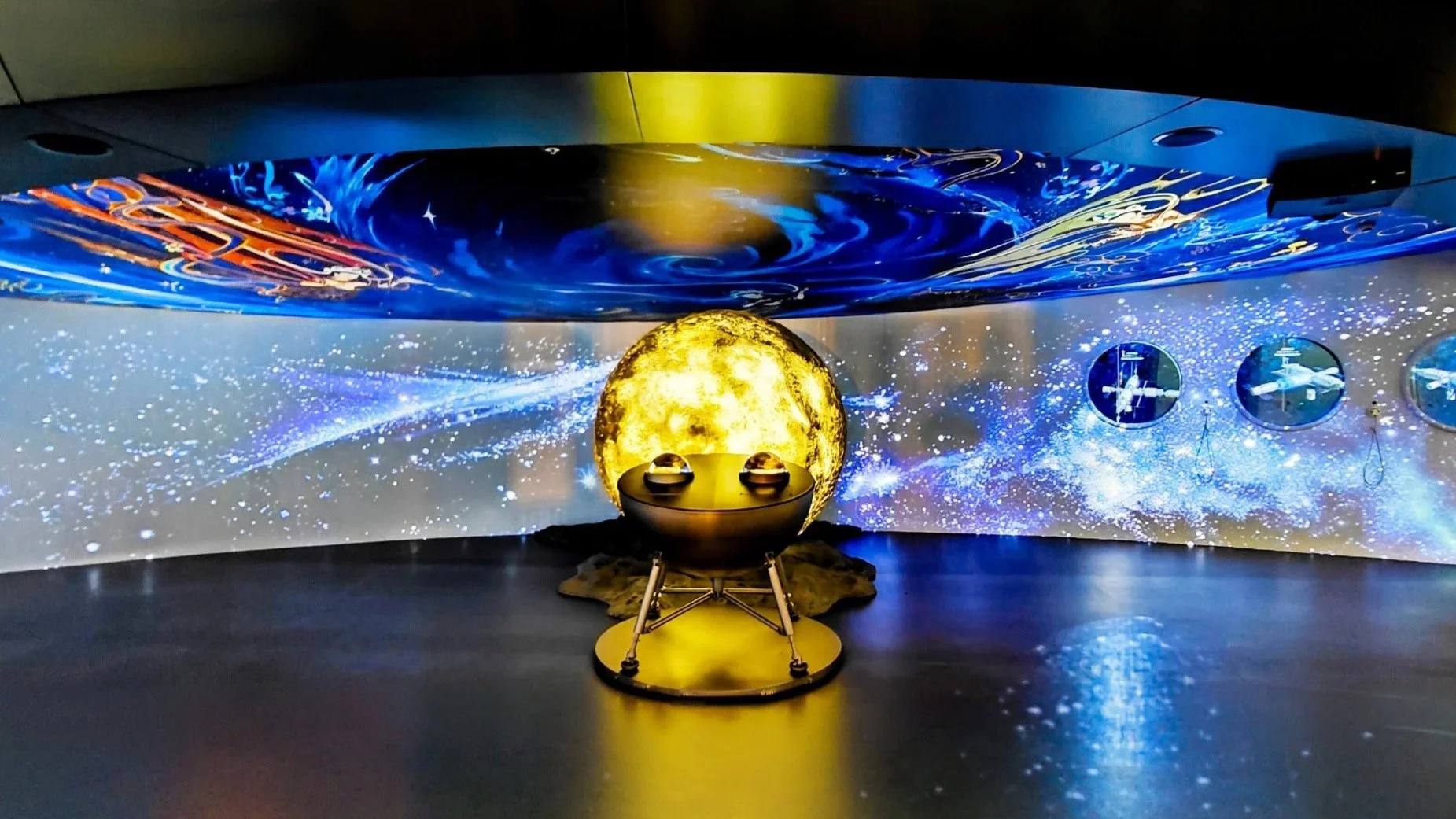 Appotronics star projector emitting golden light at Osaka World Expo, creating cosmic space patterns on walls.