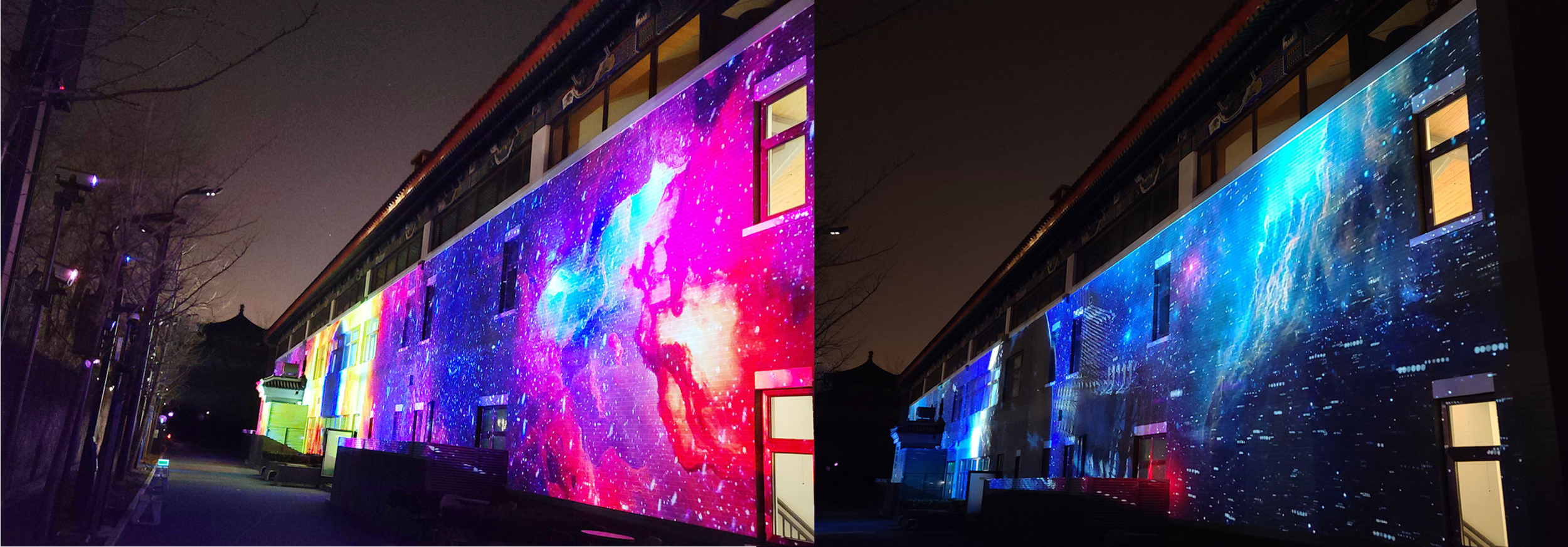 Nighttime photo of a building with a large LED screen displaying vibrant, colorful pixelated cosmic or galaxy-themed visuals.