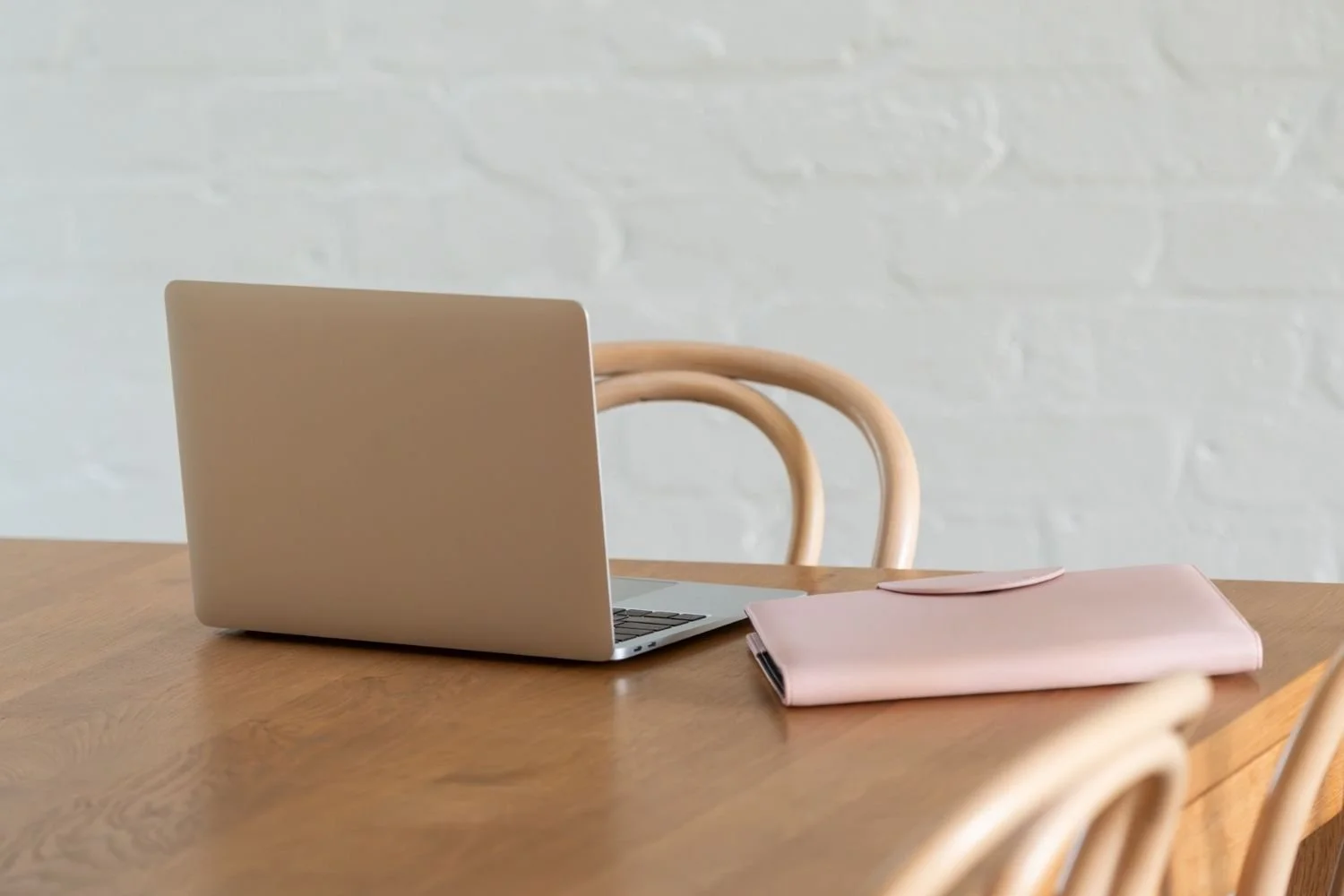 Laptop and notebook on a desk representing outplacement services and workplace transition support.