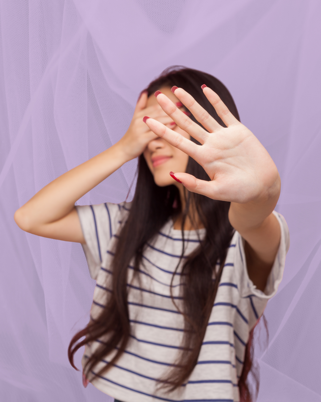 Woman covering her face and holding her hand out, expressing the feeling of freezing when speaking French — overcome your fear with online French lessons