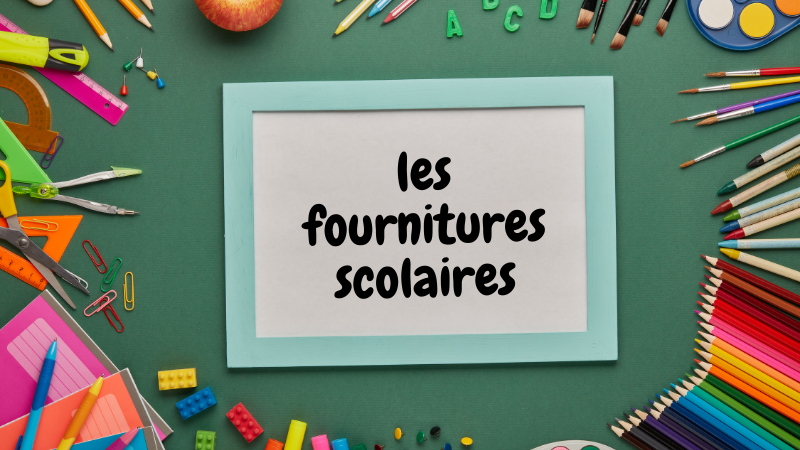 School supplies arranged around a framed paper with "les fournitures scolaires" text. Green background, colorful pens, pencils, and stationery.